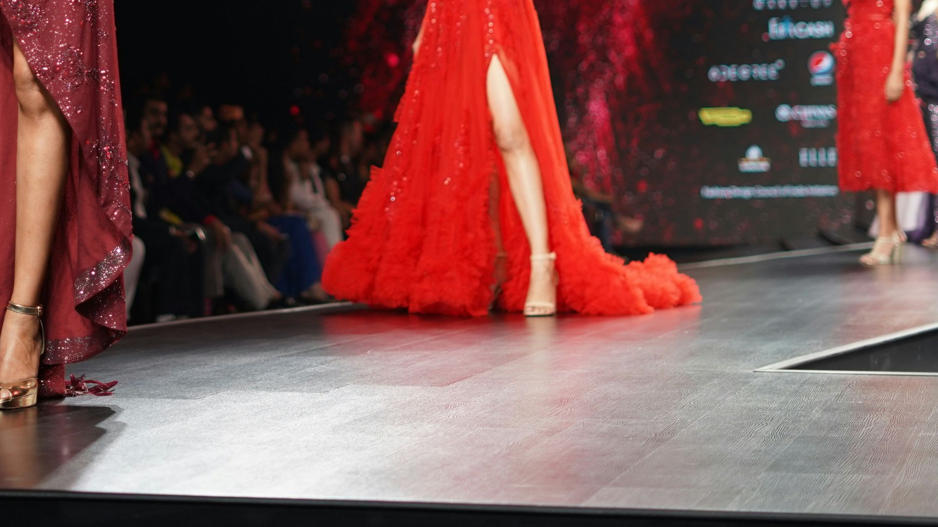woman wearing maroon one-shoulder slit-side dress