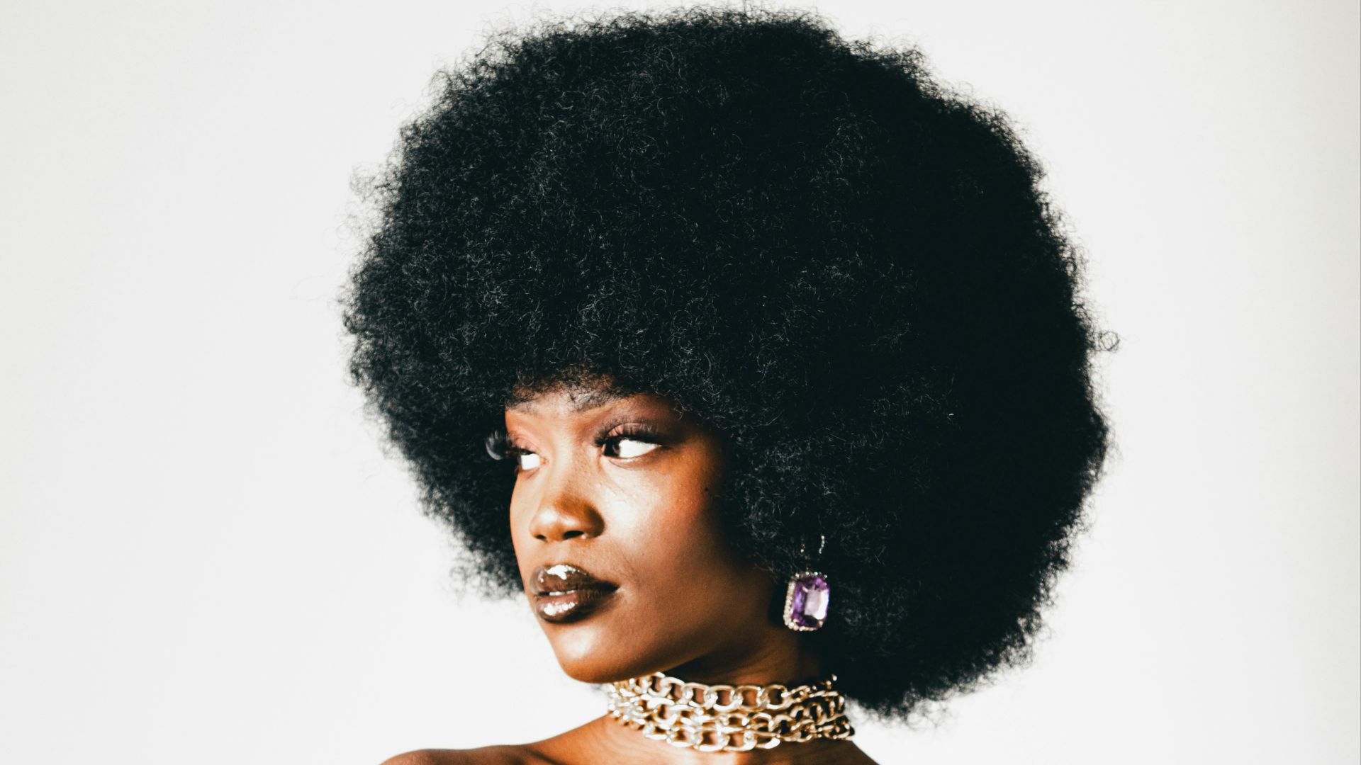 a woman with an afro is posing for a picture