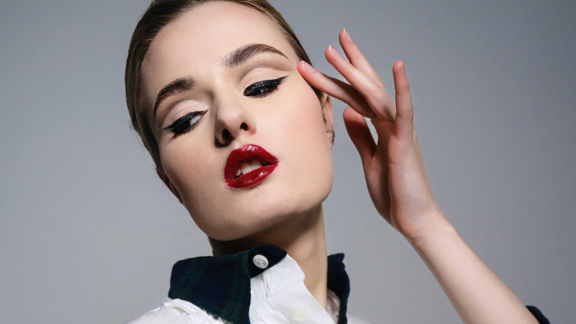 A woman wearing a white dress and black gloves