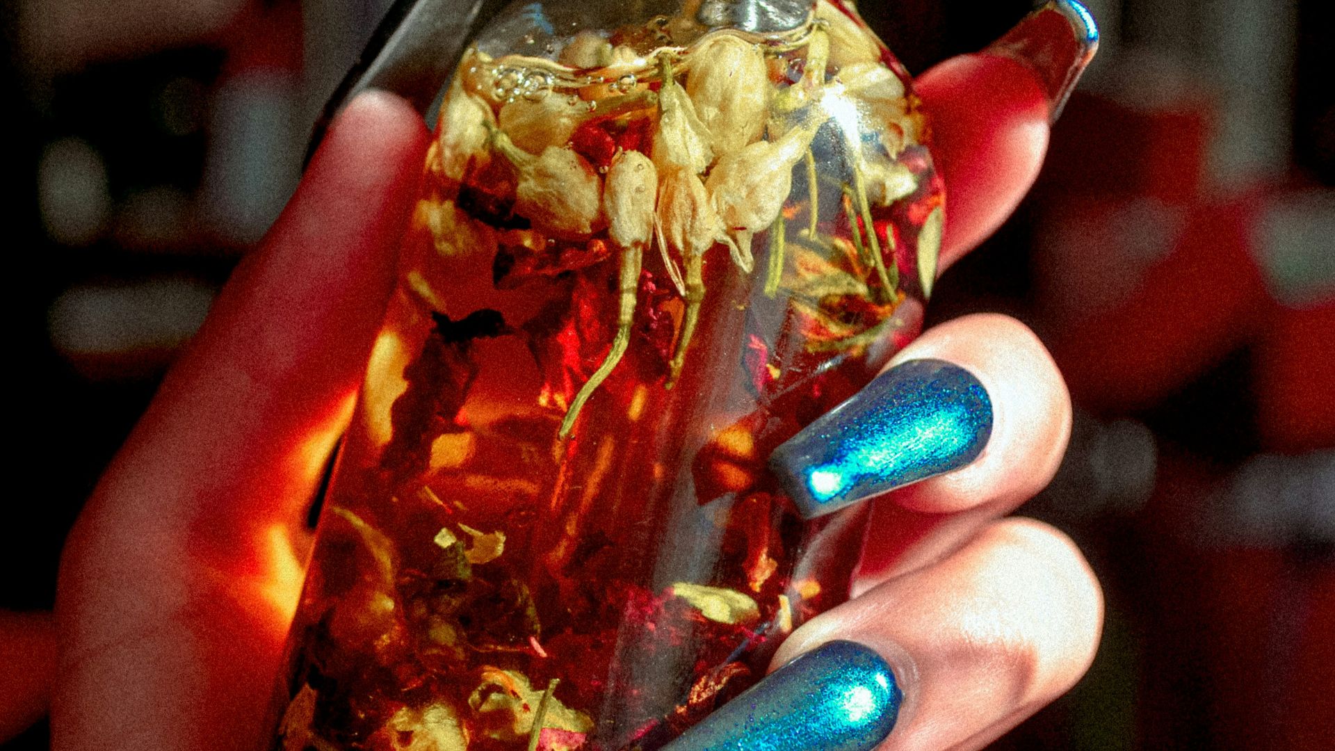 a person holding a bottle of liquid and a knife