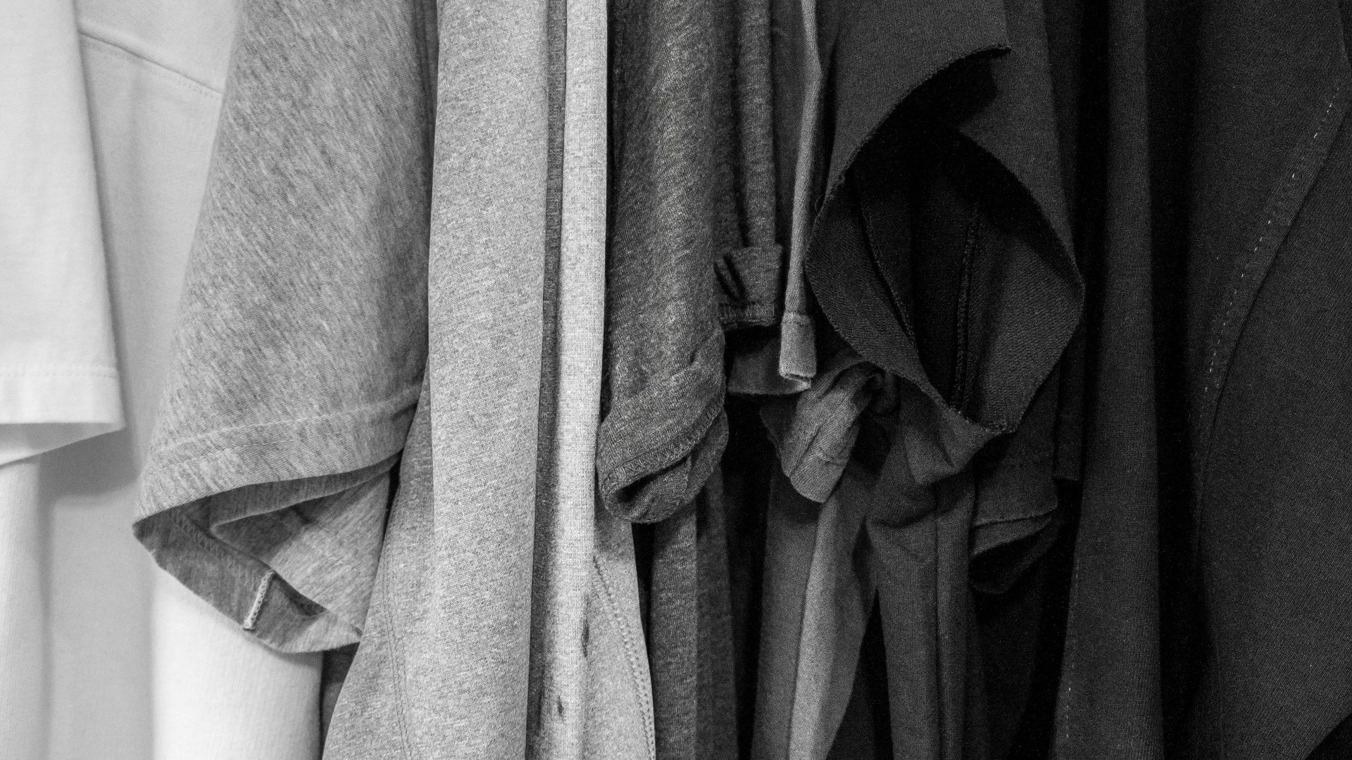 grayscale photography of assorted clothes