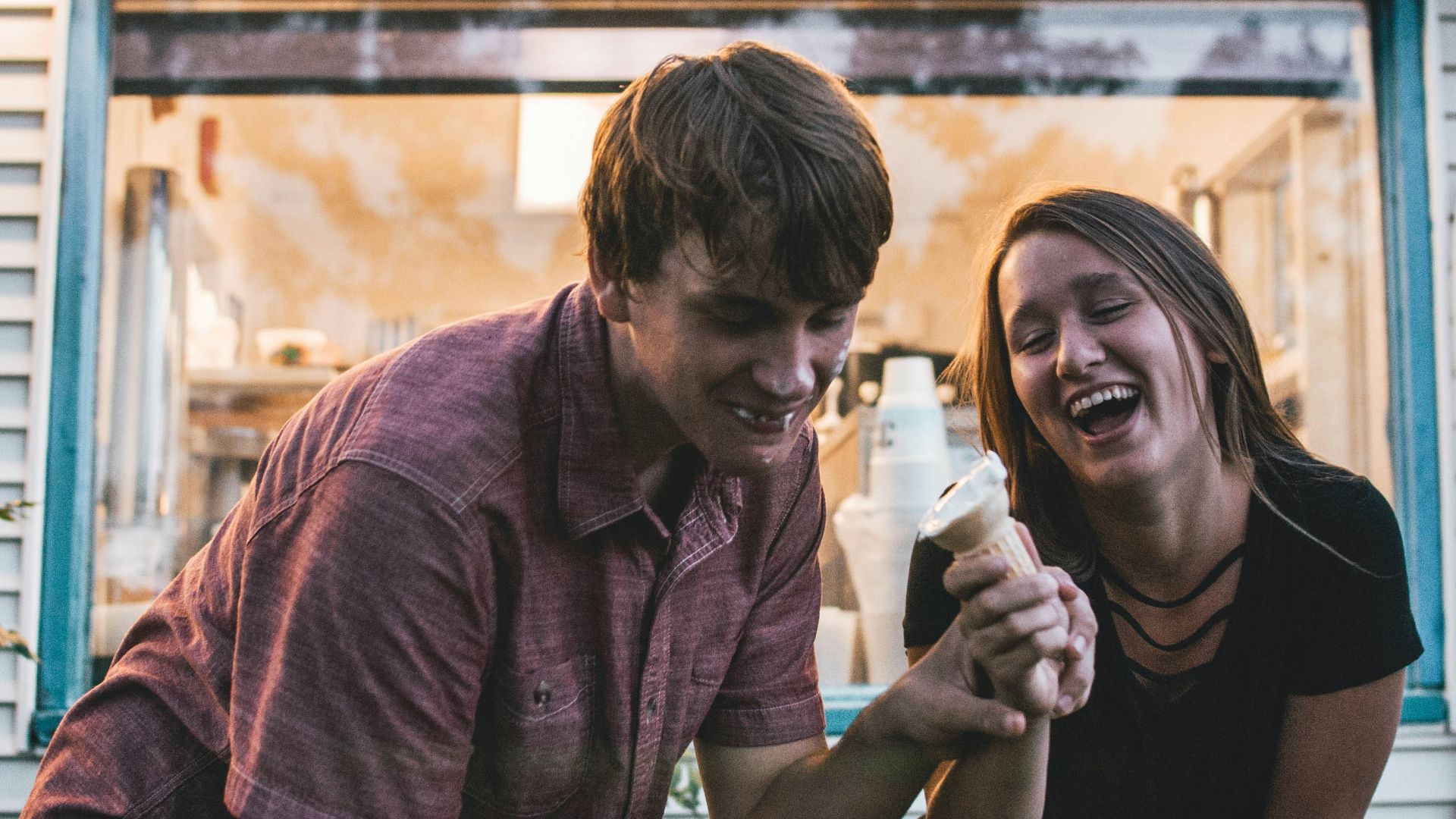 man and woman eating ice cream during daytime