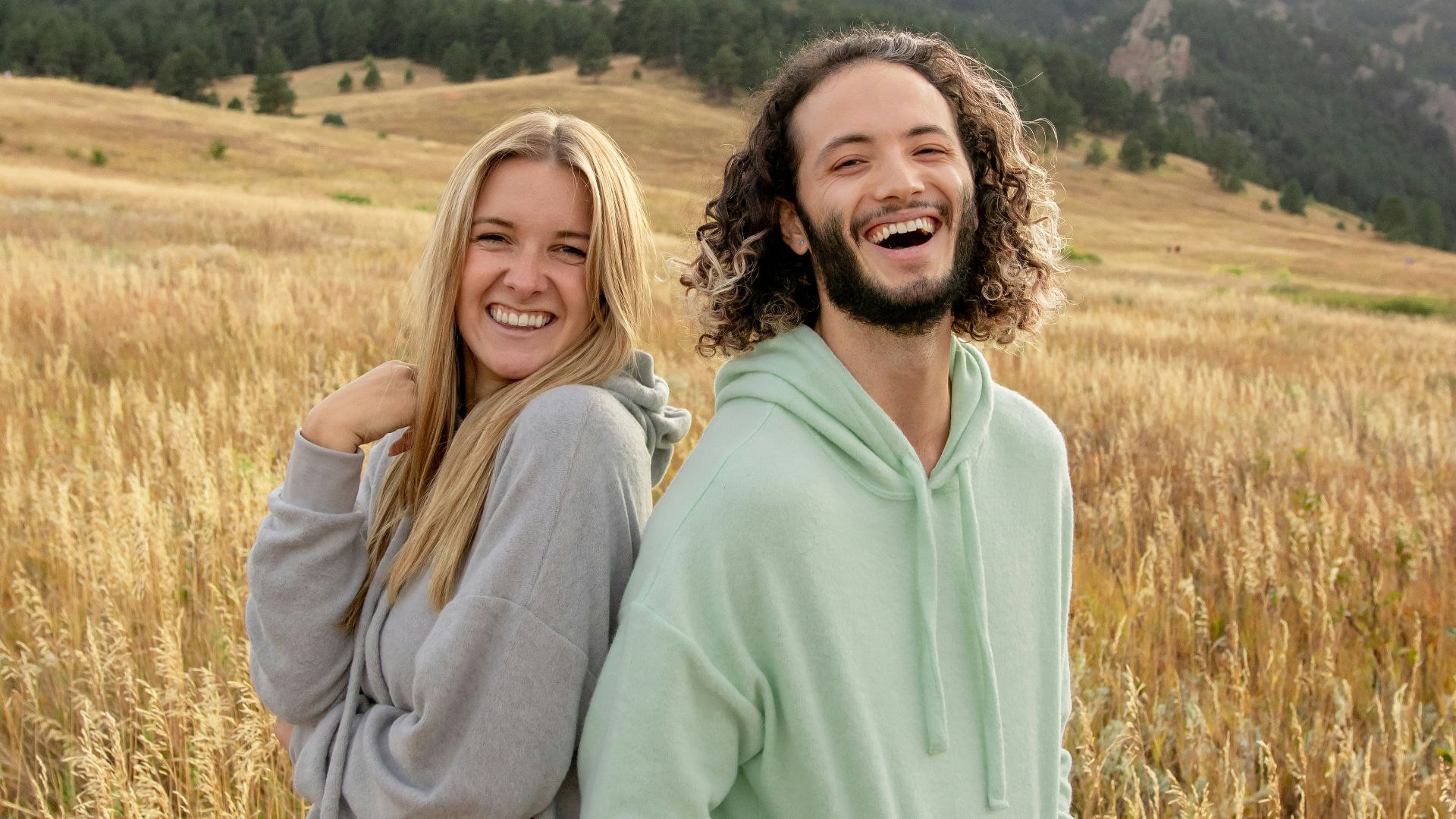 a man and a woman standing in a field