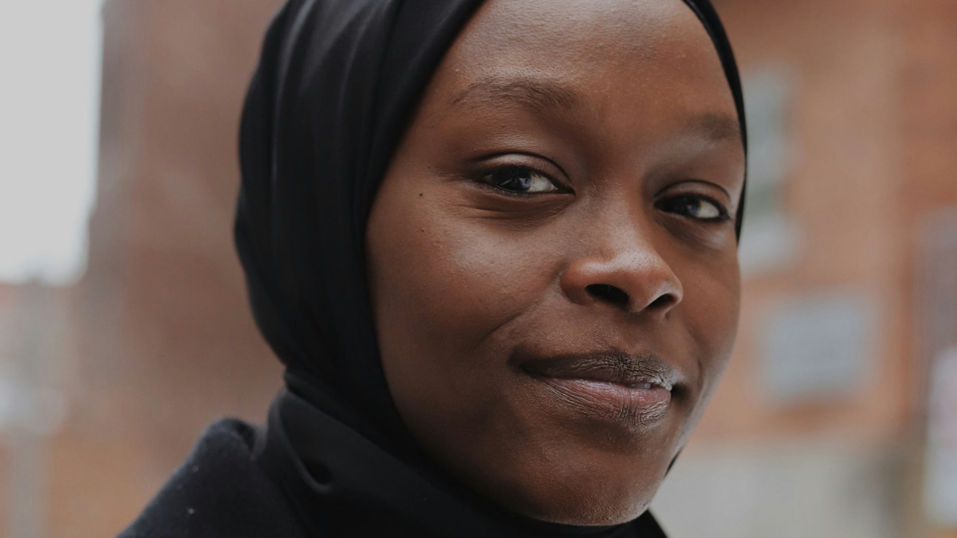 woman in black hijab and black coat