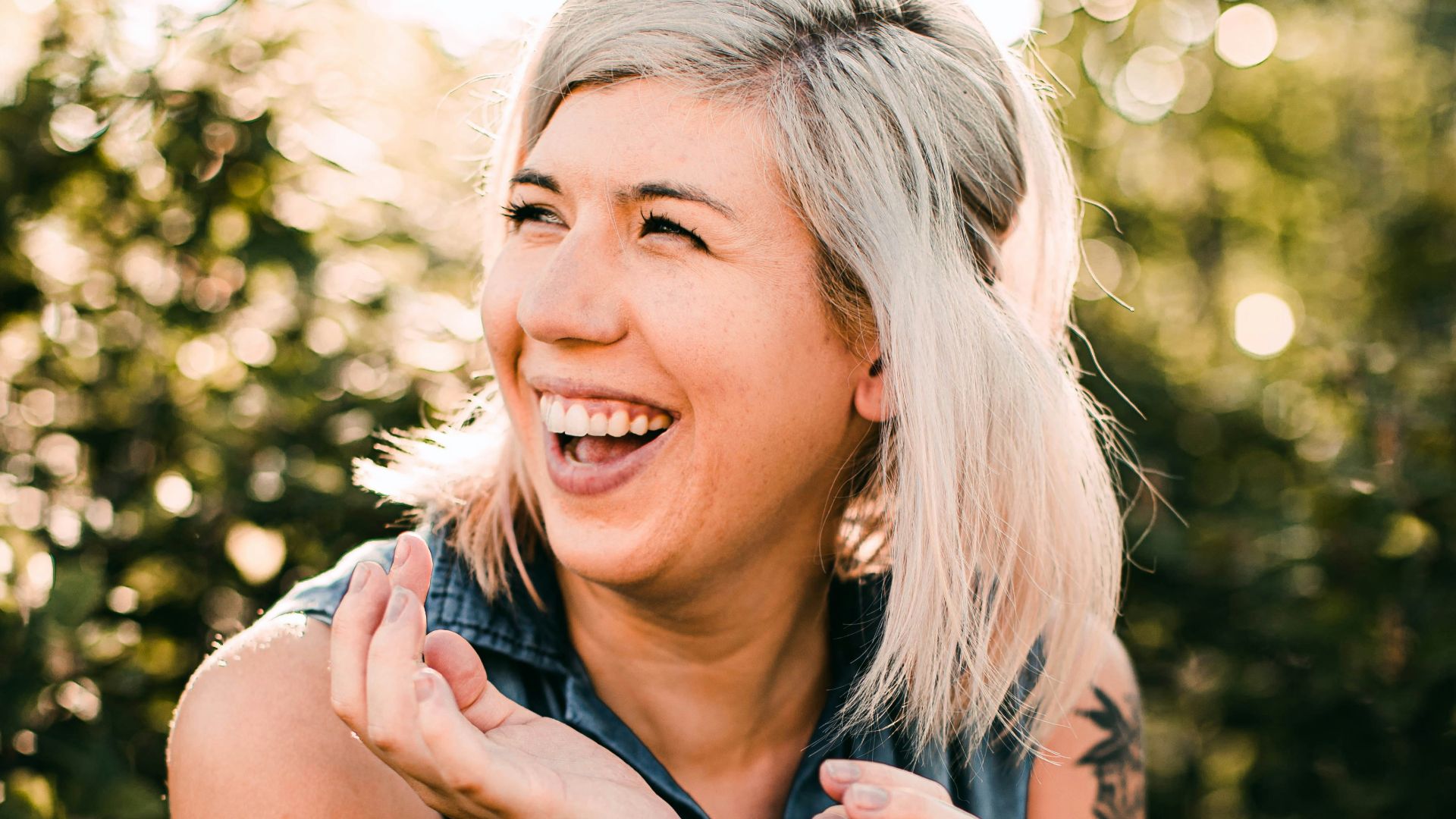 woman in black tank top smiling