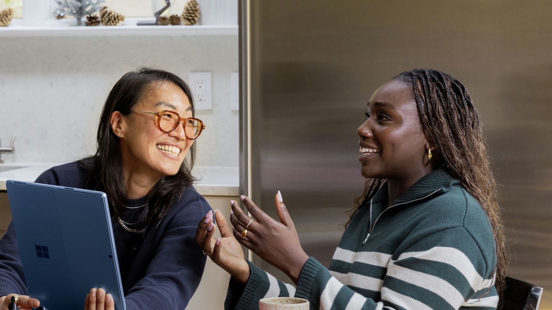 a woman sitting at a table in front of a window