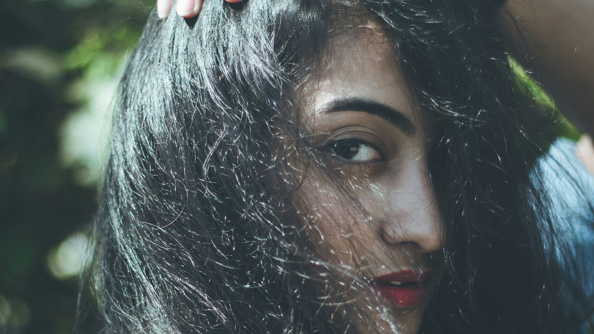 woman in white and blue shirt with red lipstick