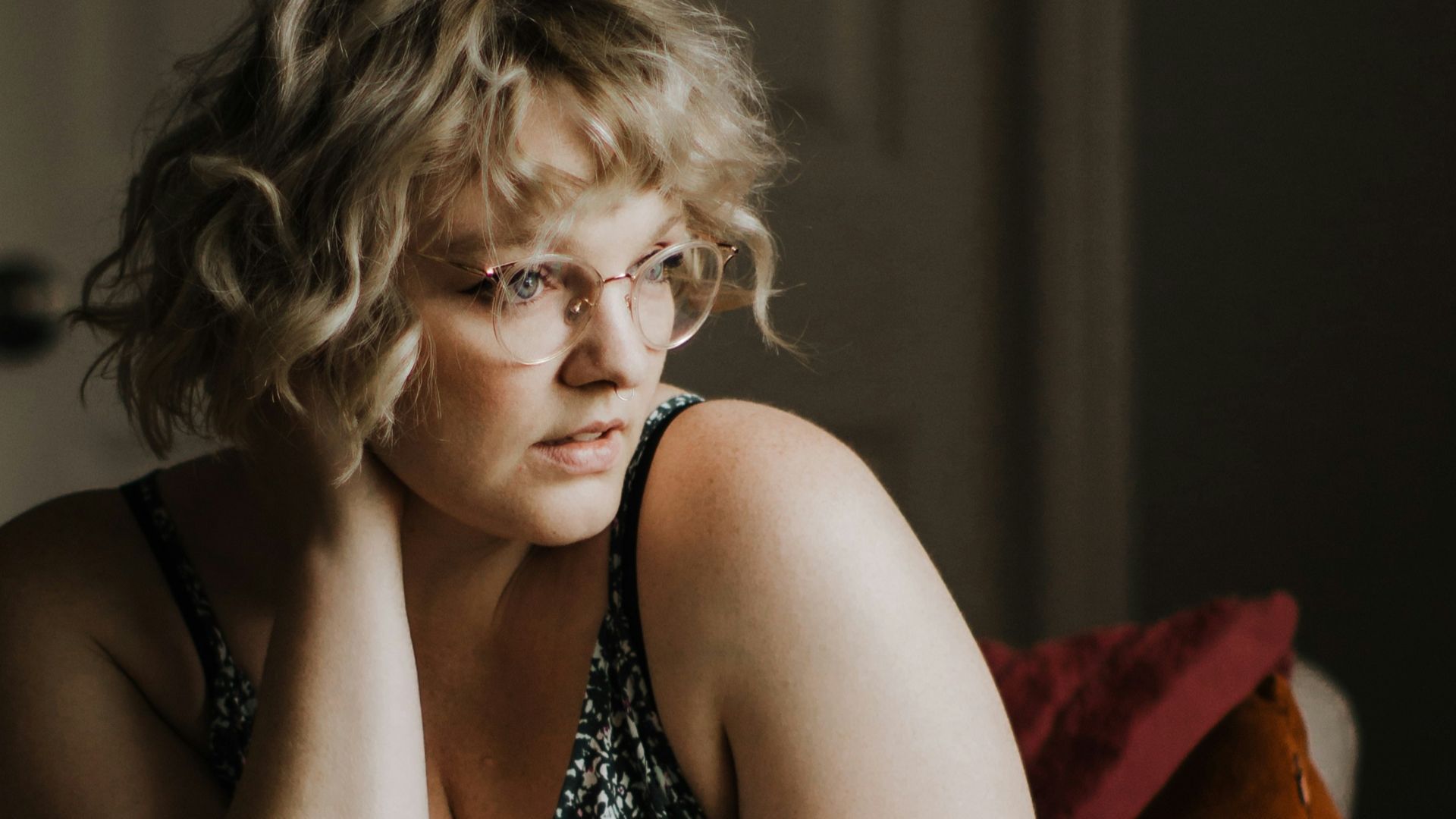 woman in black and white dress sitting on couch