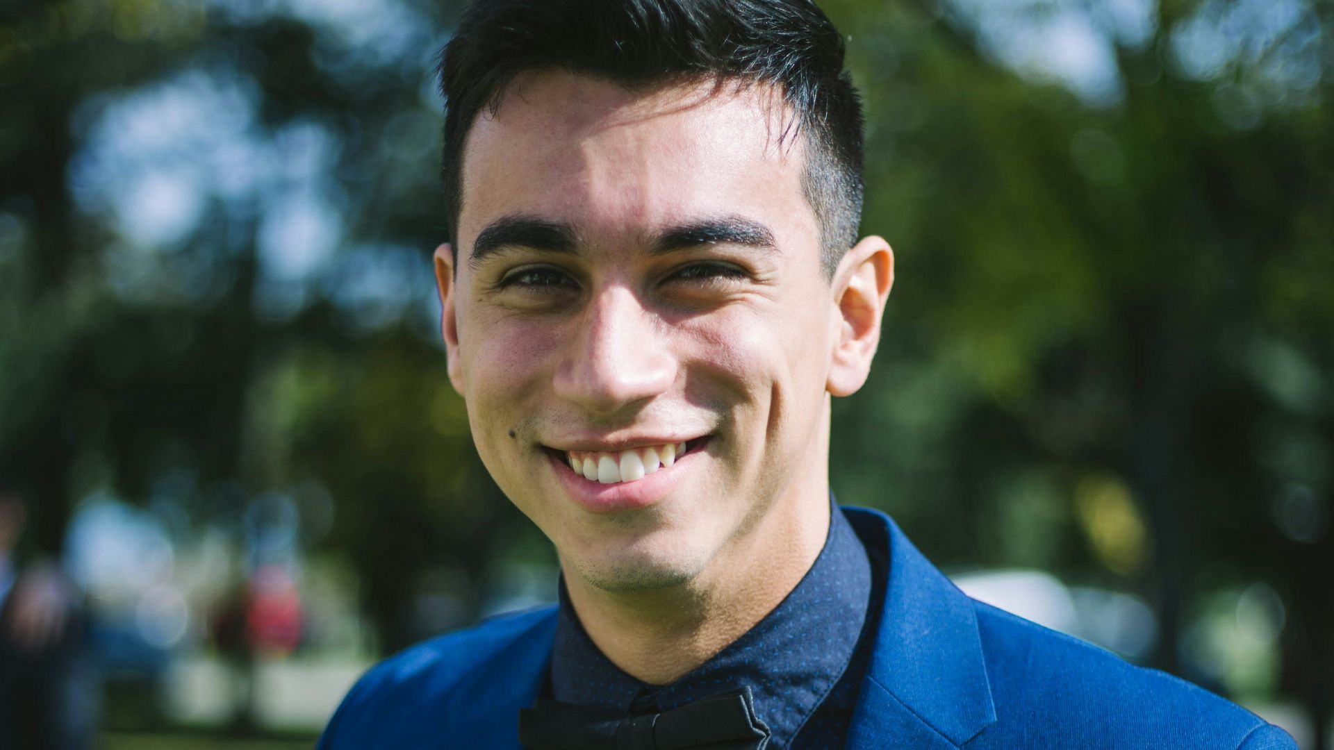 man in blue suit jacket smiling