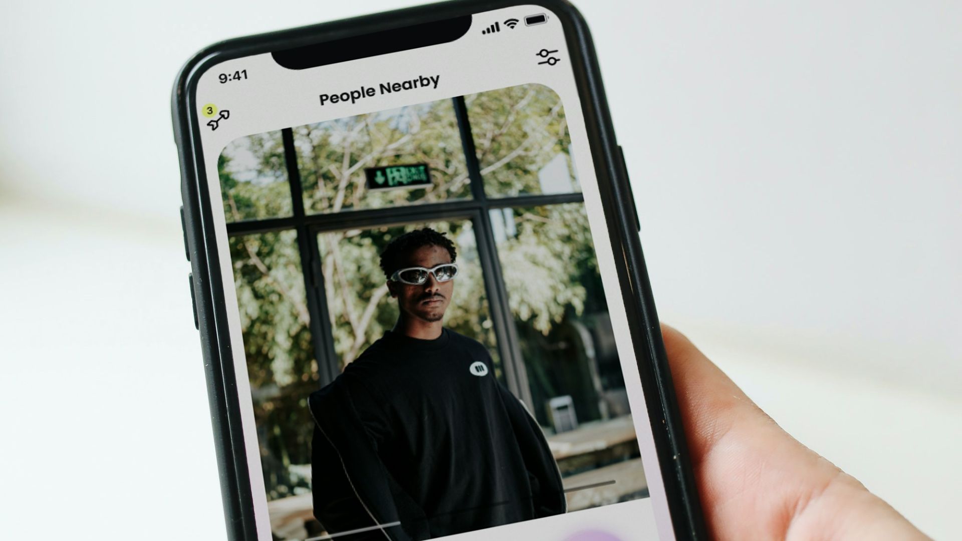 a person holding a cell phone with a picture of a man on it