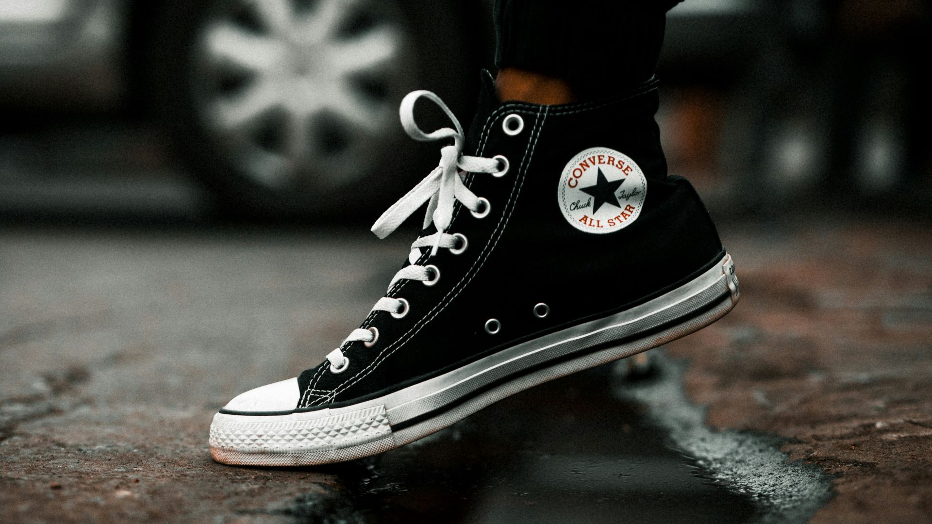 unpaired black and white high-top sneaker
