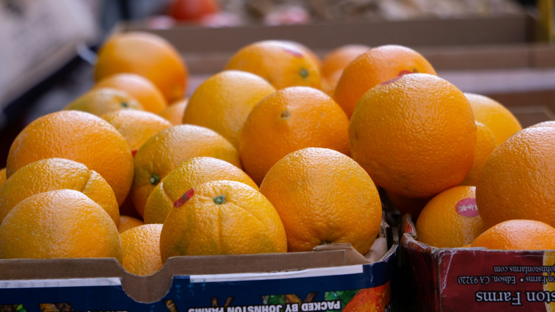 a box of oranges sitting on top of a table