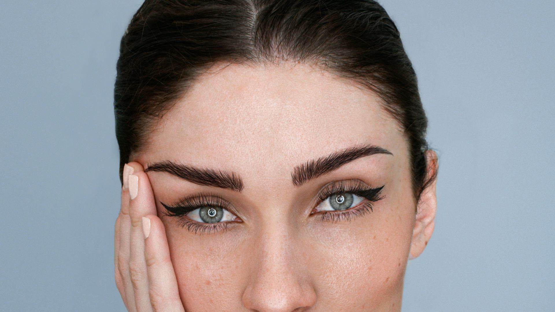 a woman with her hand on her face
