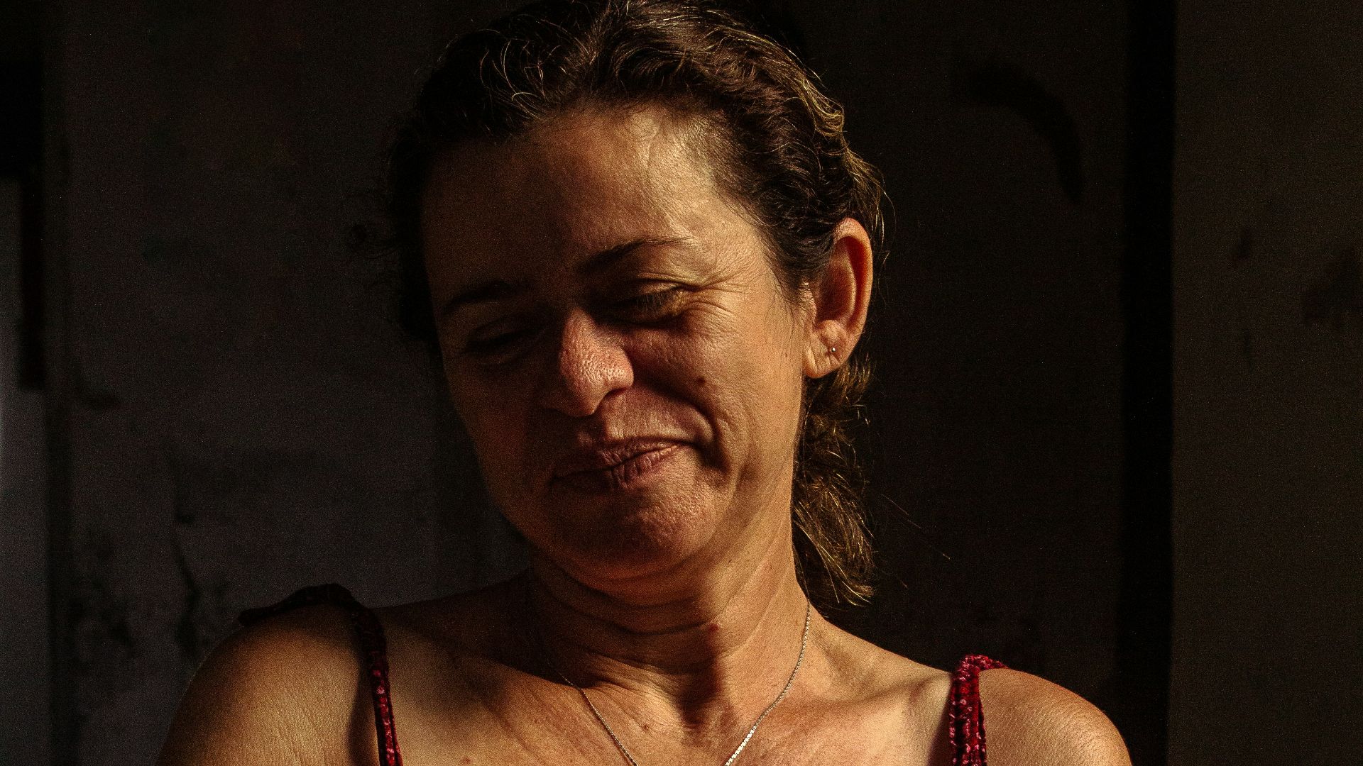 a woman in a red dress sitting down