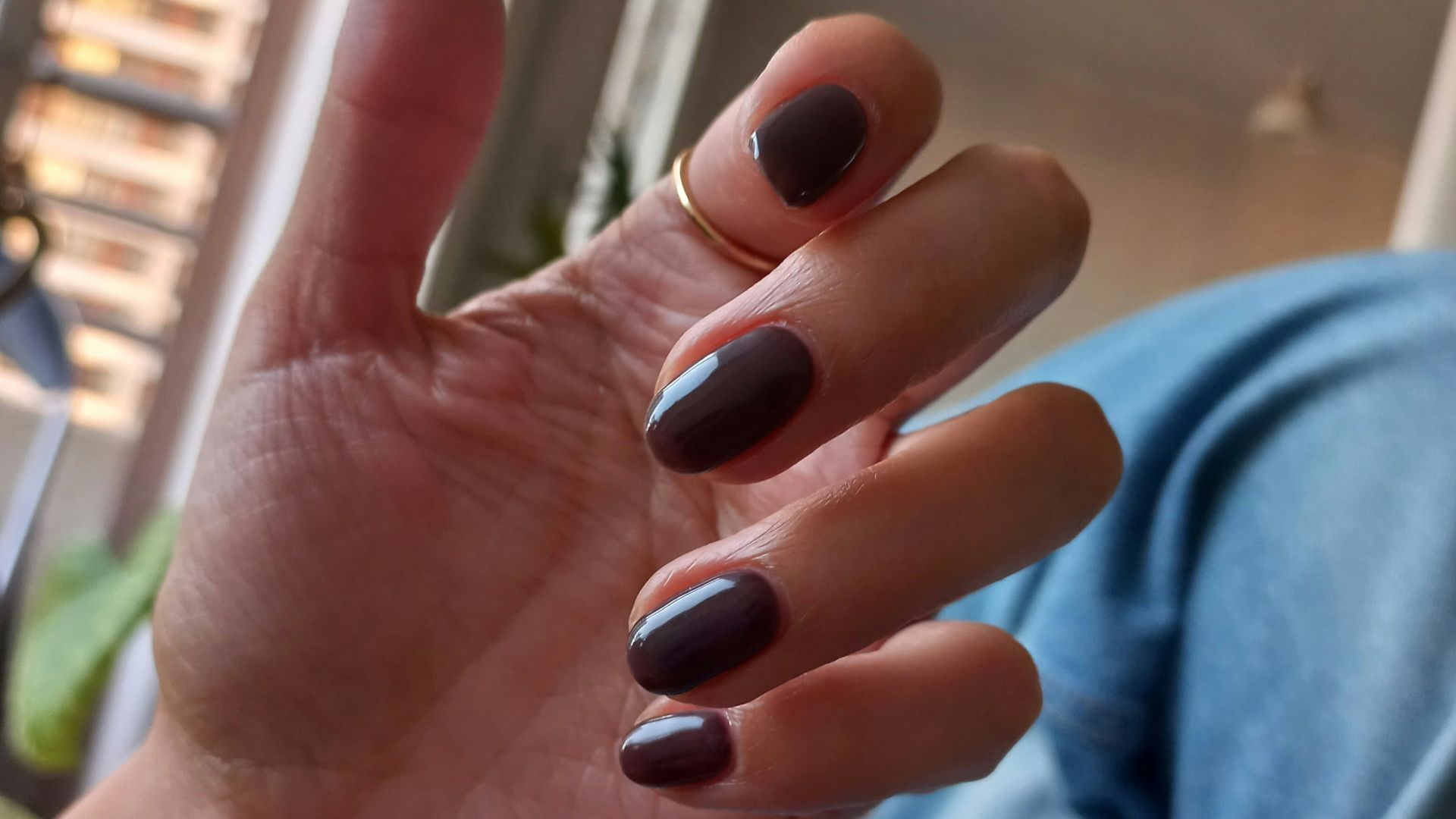 Hand with painted nails and a ring.