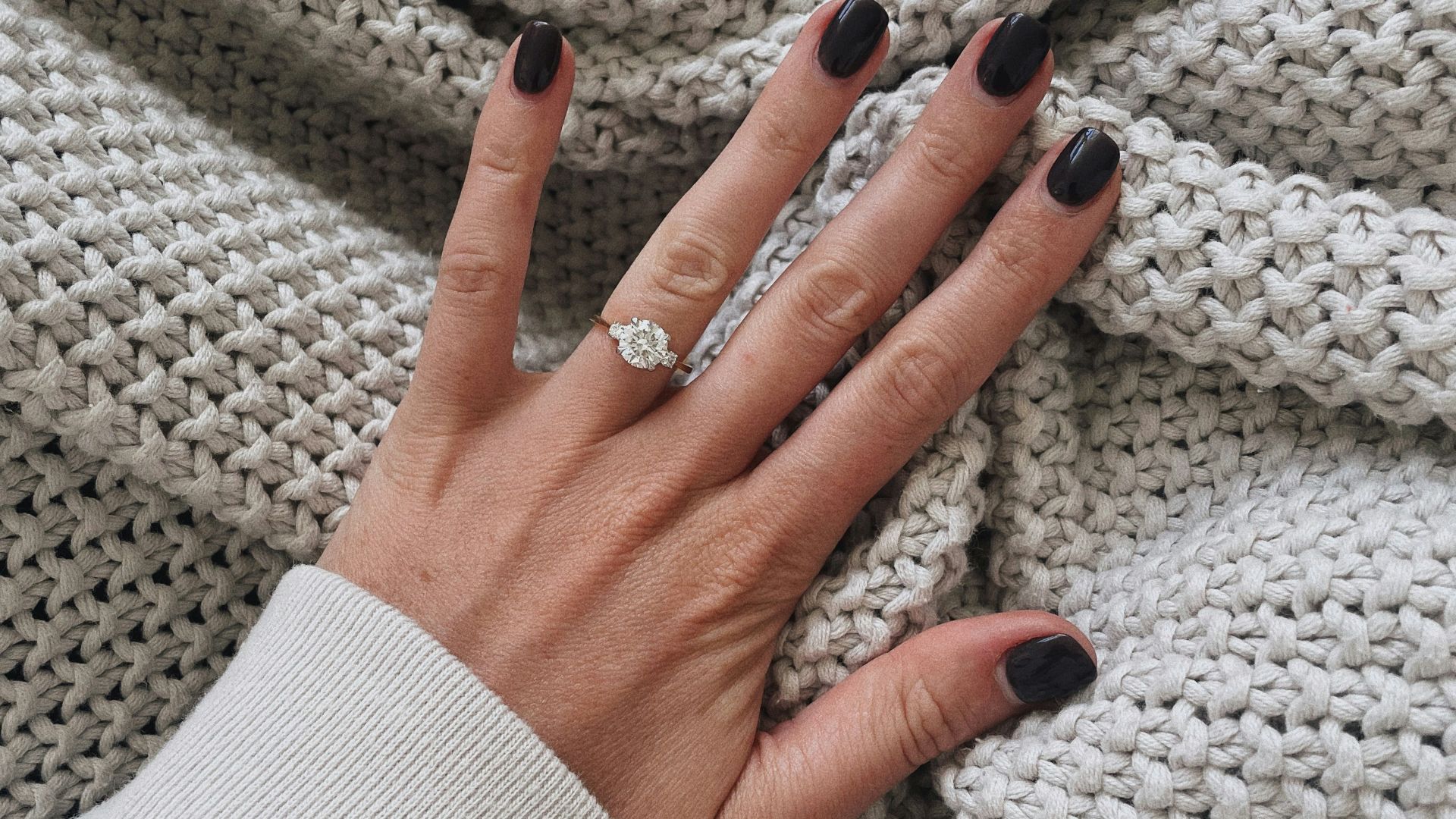 a woman's hand on a blanket