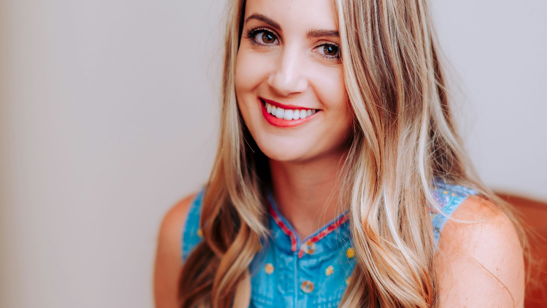 smiling girl in blue sleeveless dress