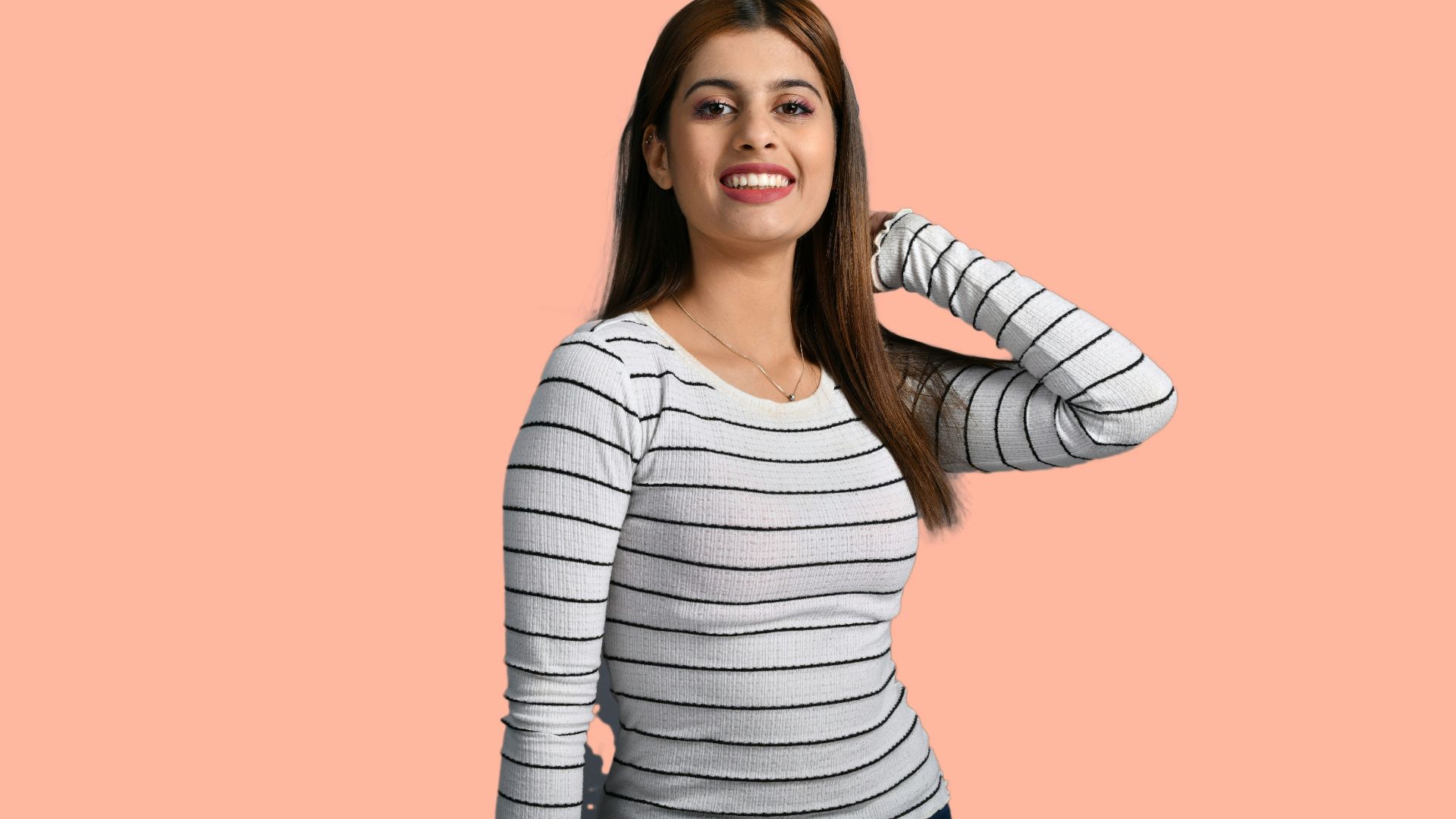 a woman smiling with a pink background