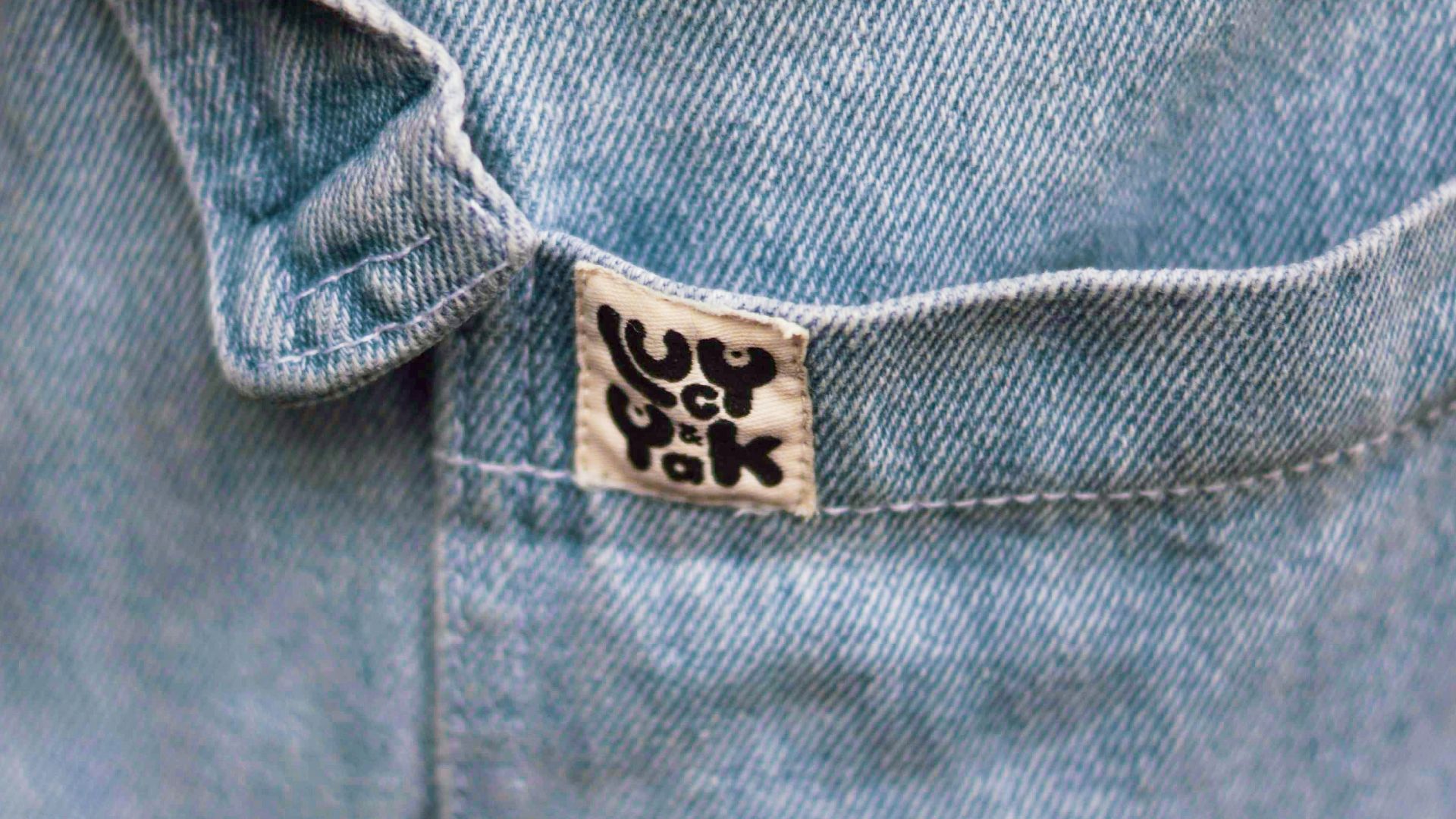 a close up of a person wearing a jean jacket