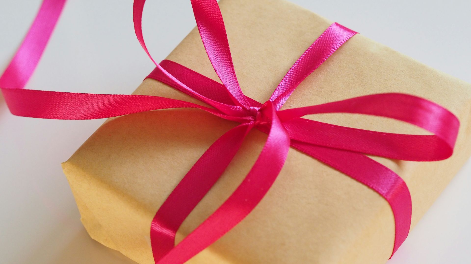 brown gift box with pink ribbon
