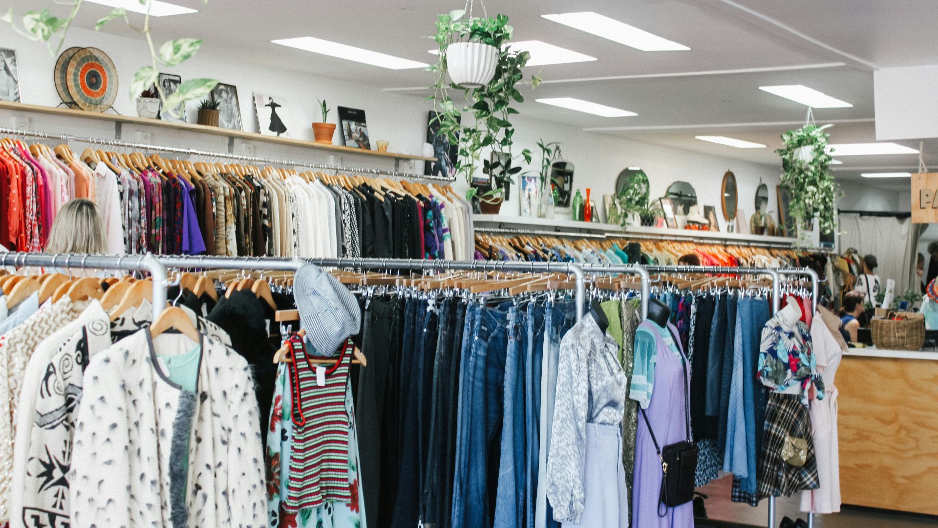 assorted-color clothes hanged inside department store with lights turned on