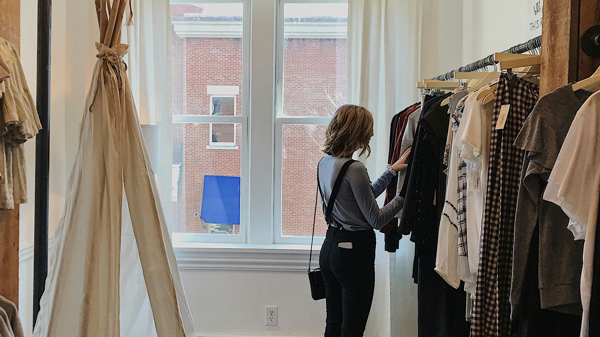 woman standing selecting clothes