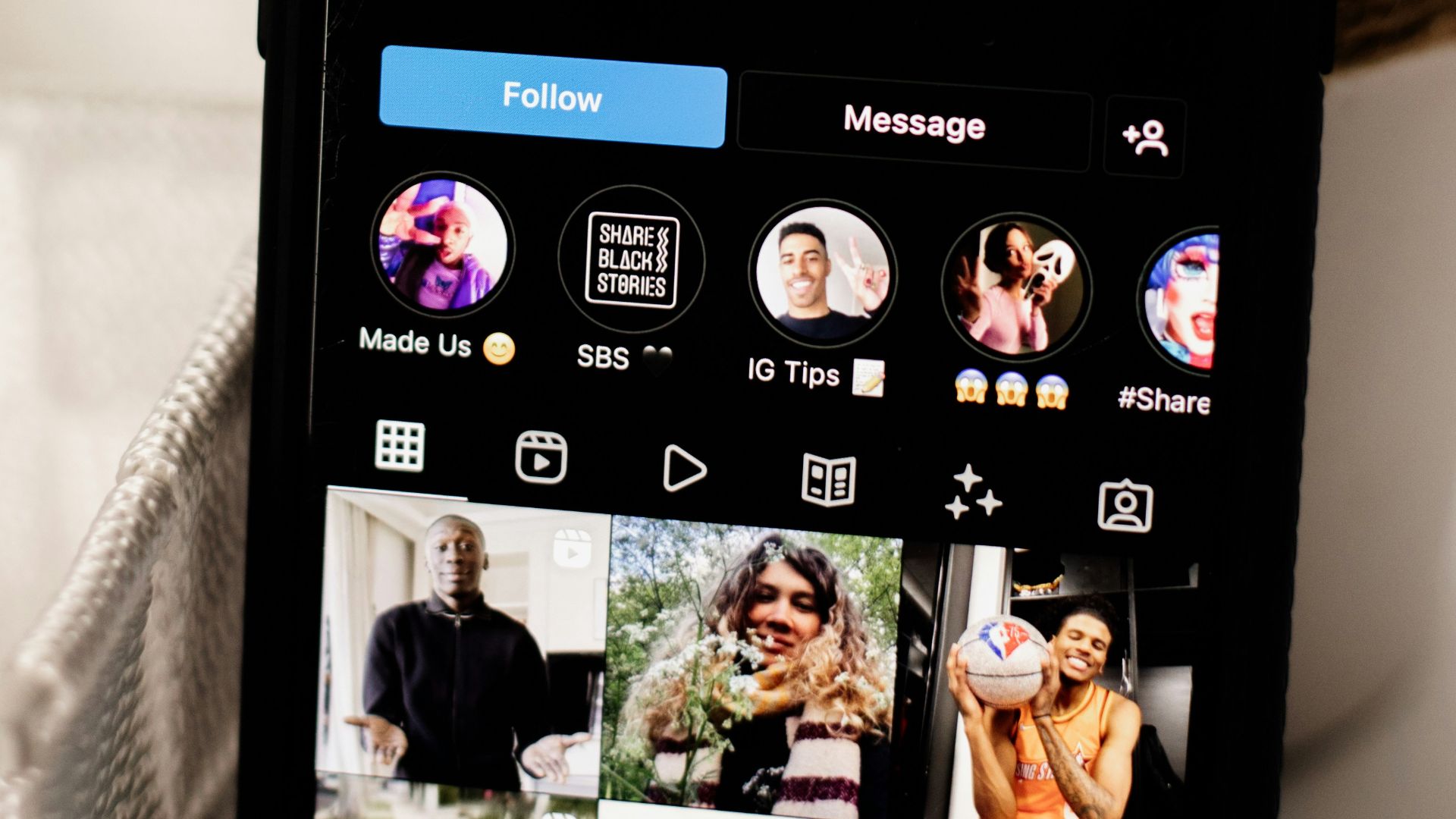 a cell phone sitting on top of a table next to a potted plant
