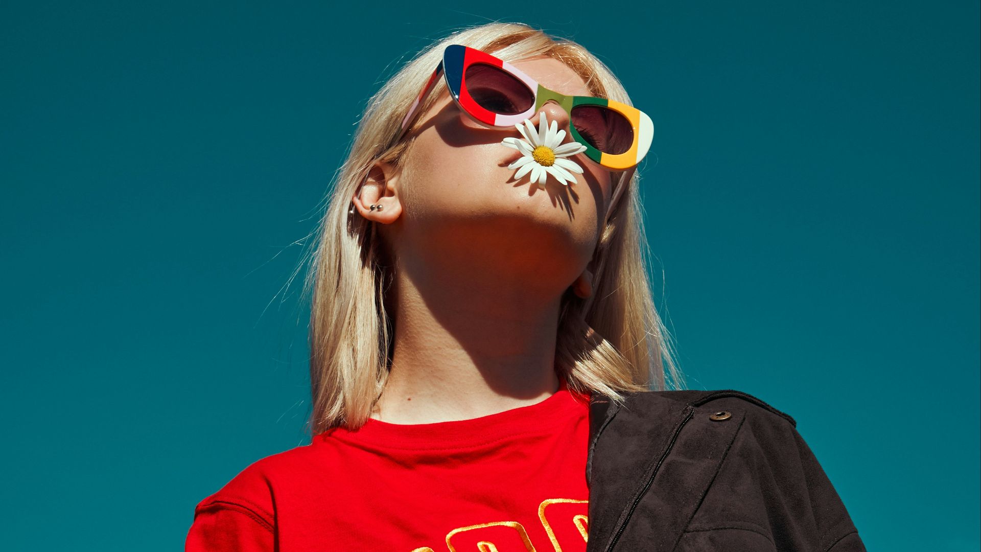 woman with sunglasses standing outdoor during daytime