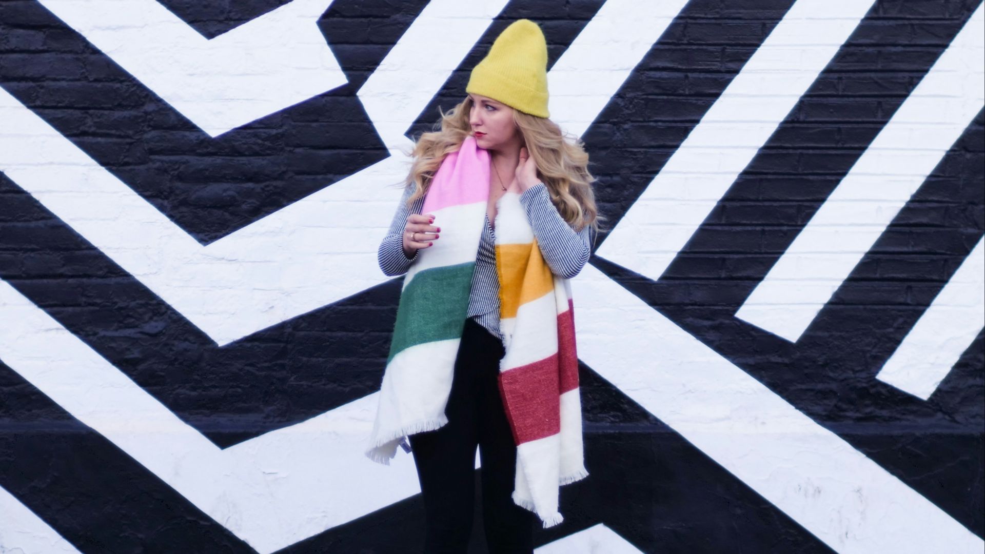 woman in green and white coat standing on pedestrian line