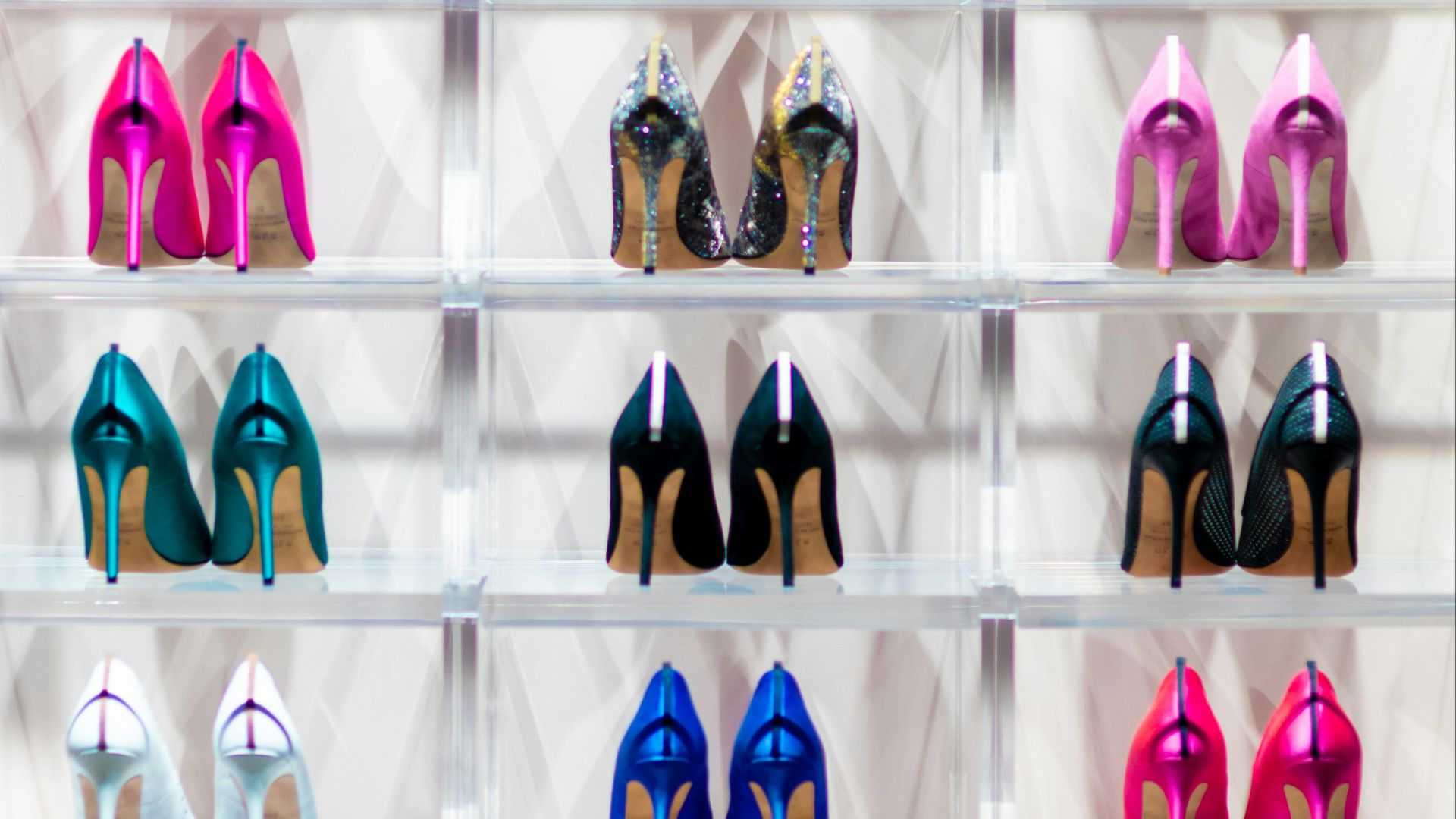 a display case filled with lots of different colored shoes