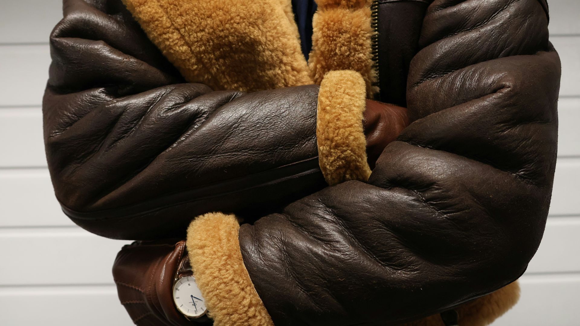 a close up of a person wearing a brown jacket