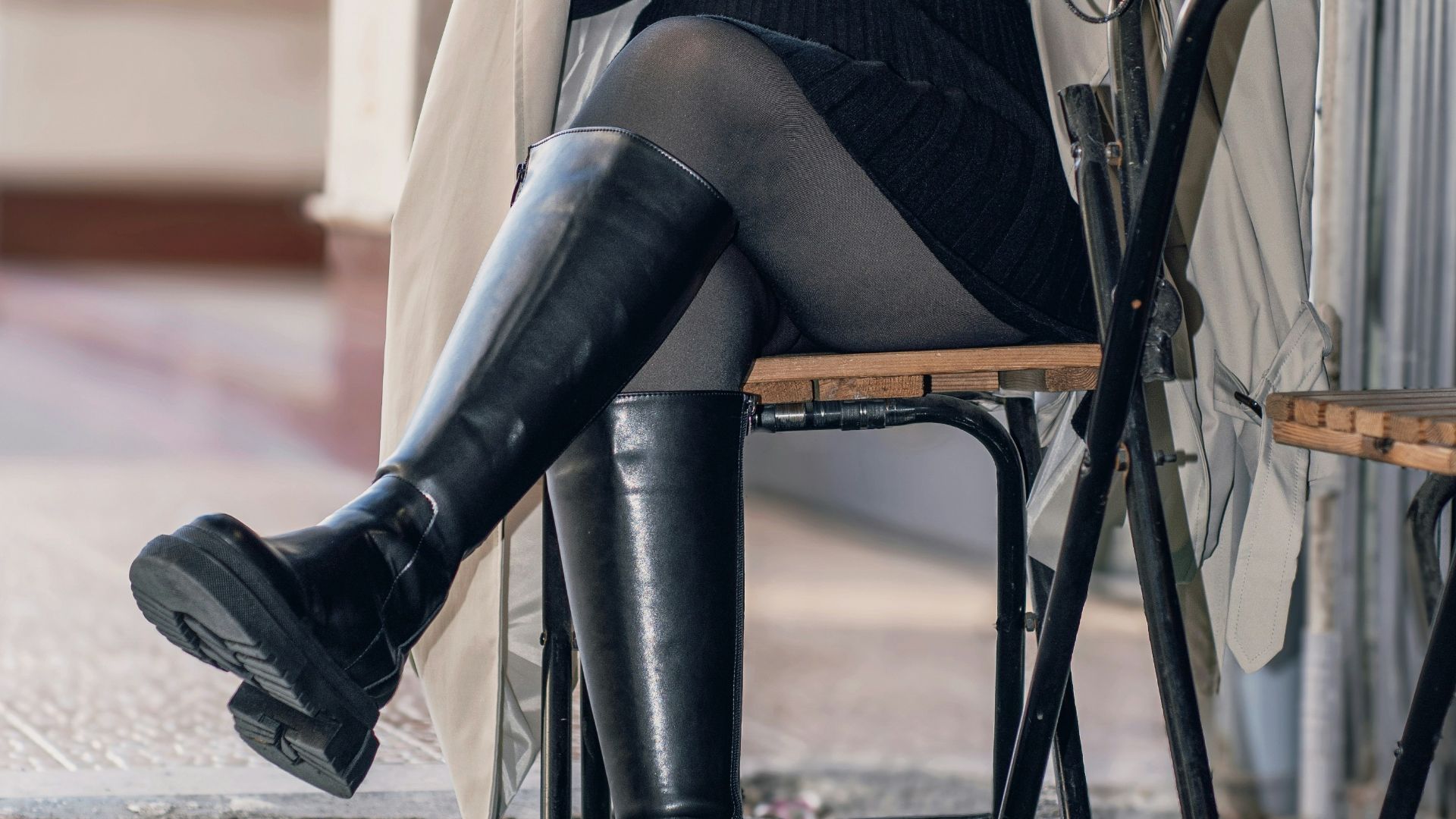 Woman with curly gray hair holding coffee cup at table