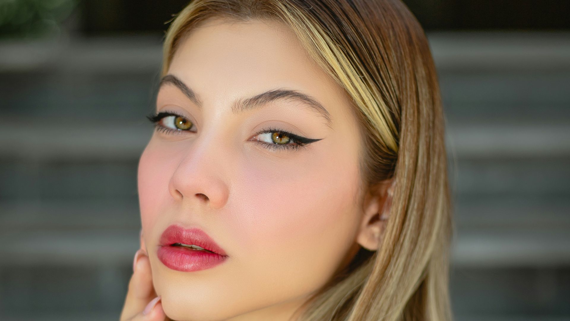 a woman with long blonde hair is posing for a picture