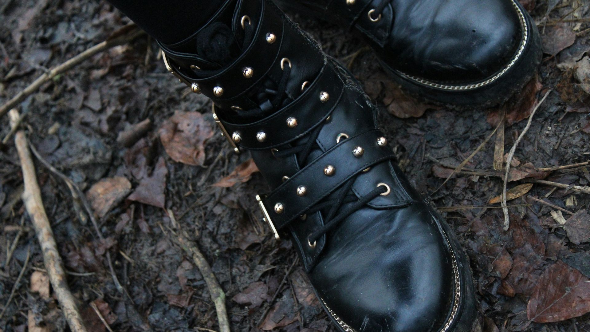 a close up of a person wearing black boots