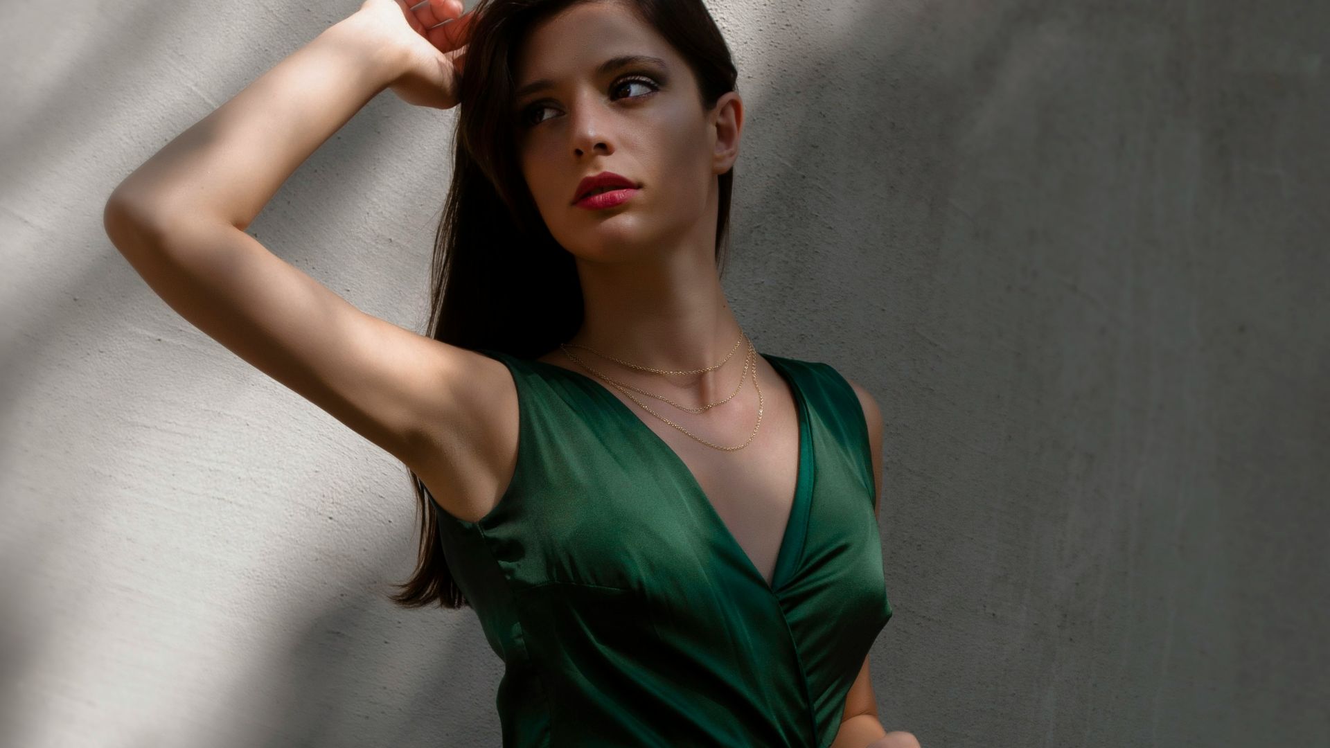 a woman in a green dress posing for a picture