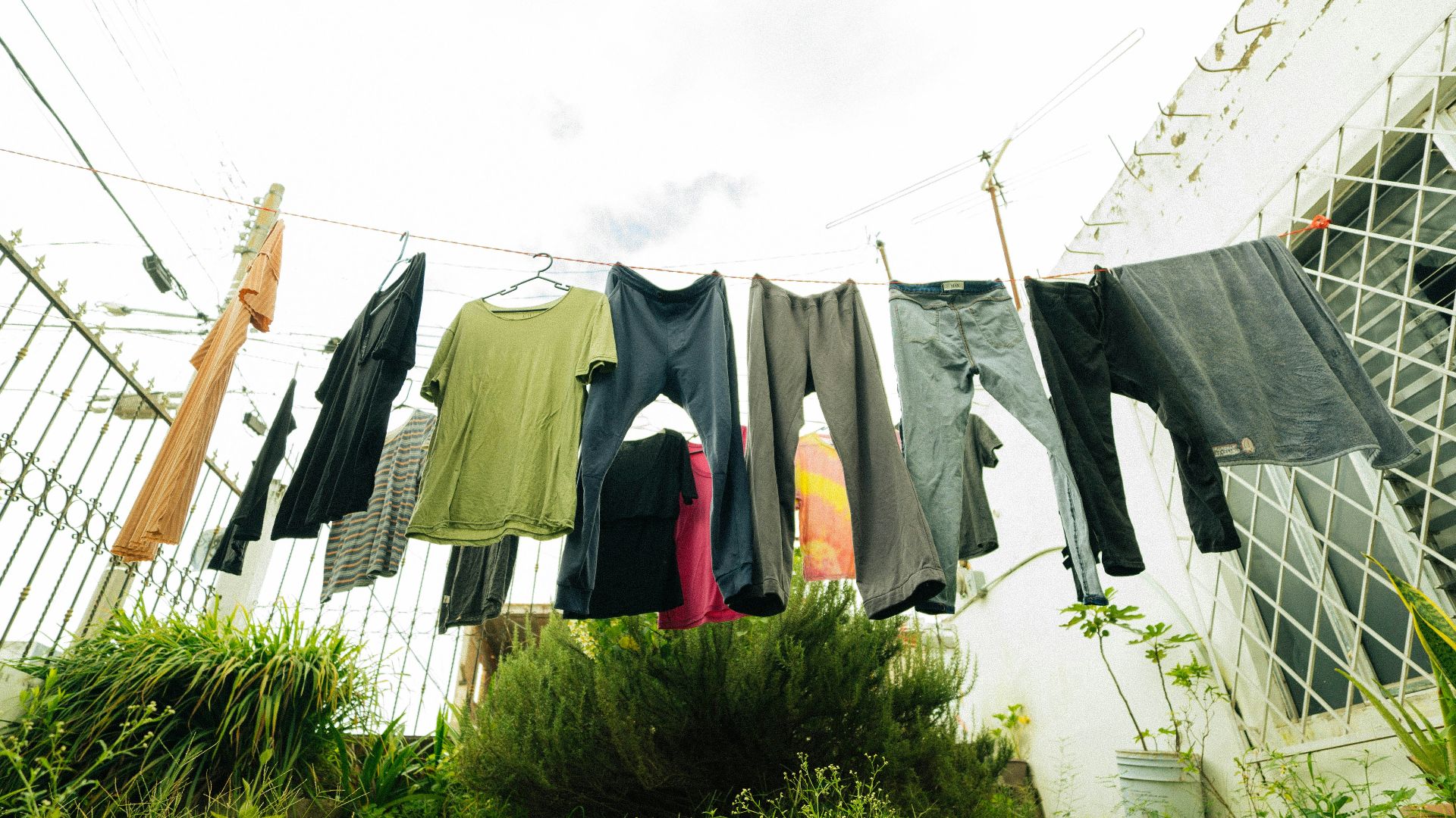 clothes hanging on a clothes line outside a house