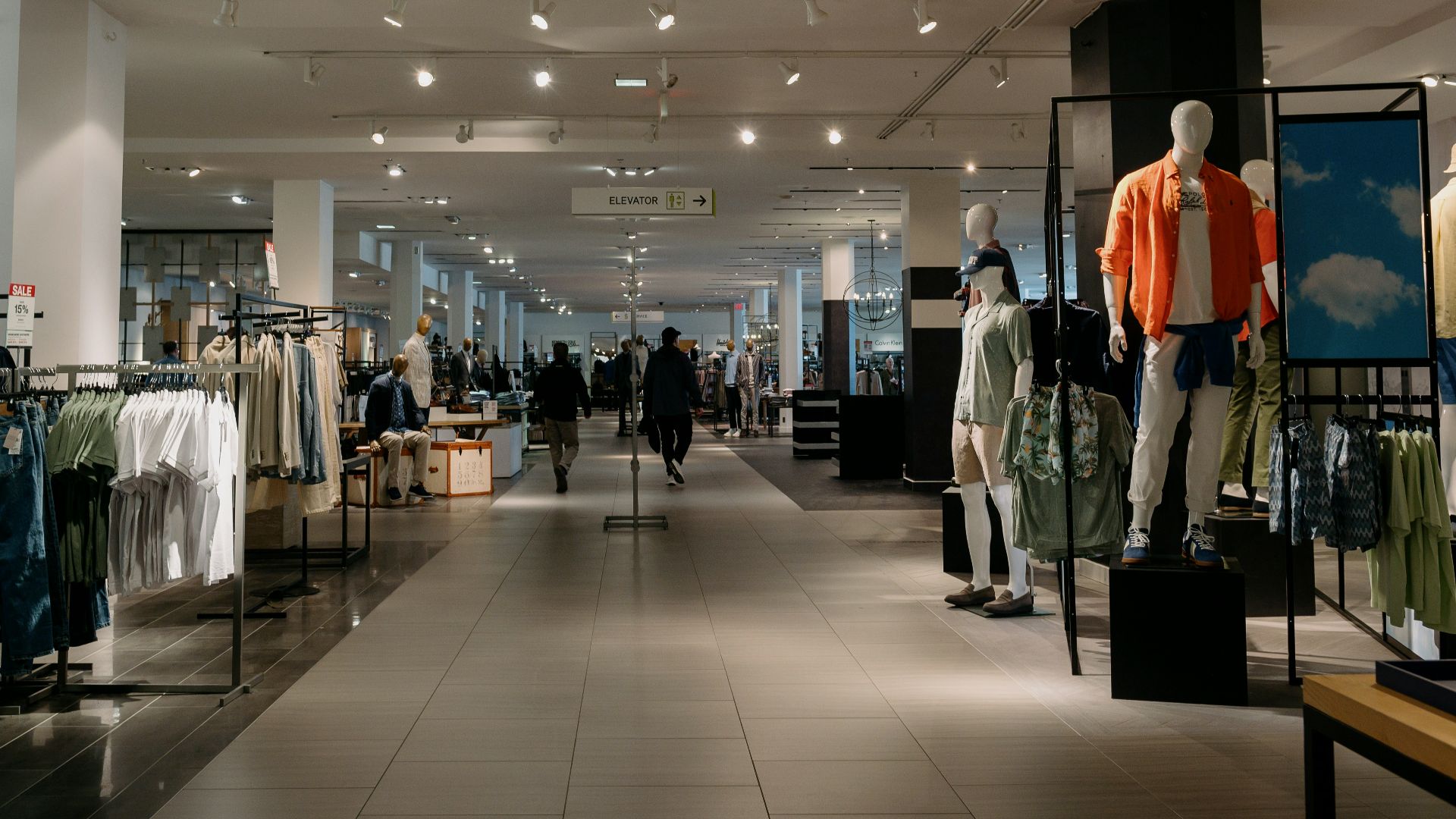 Inside of a department store with clothes on display.