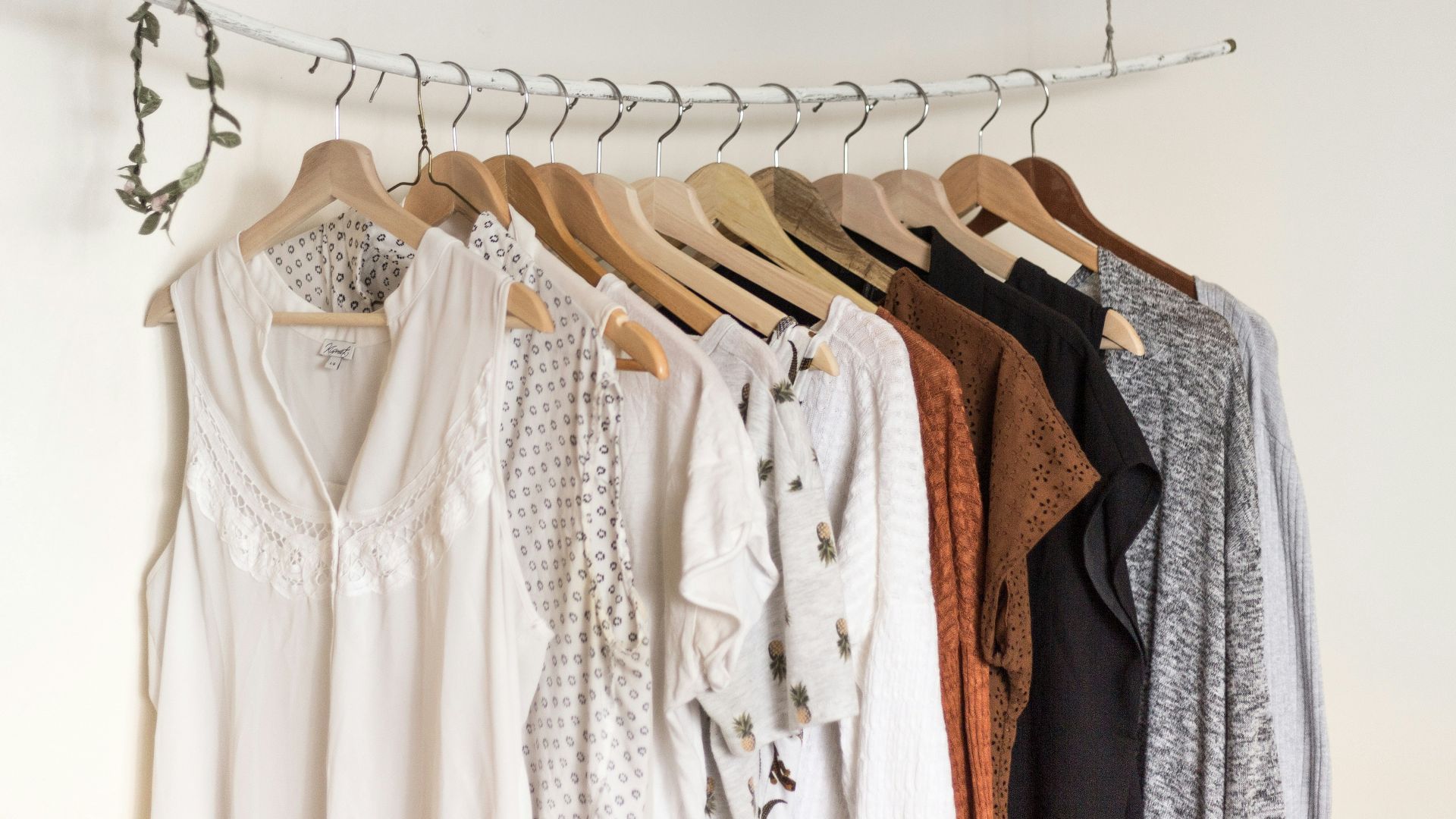 assorted clothes in wooden hangers