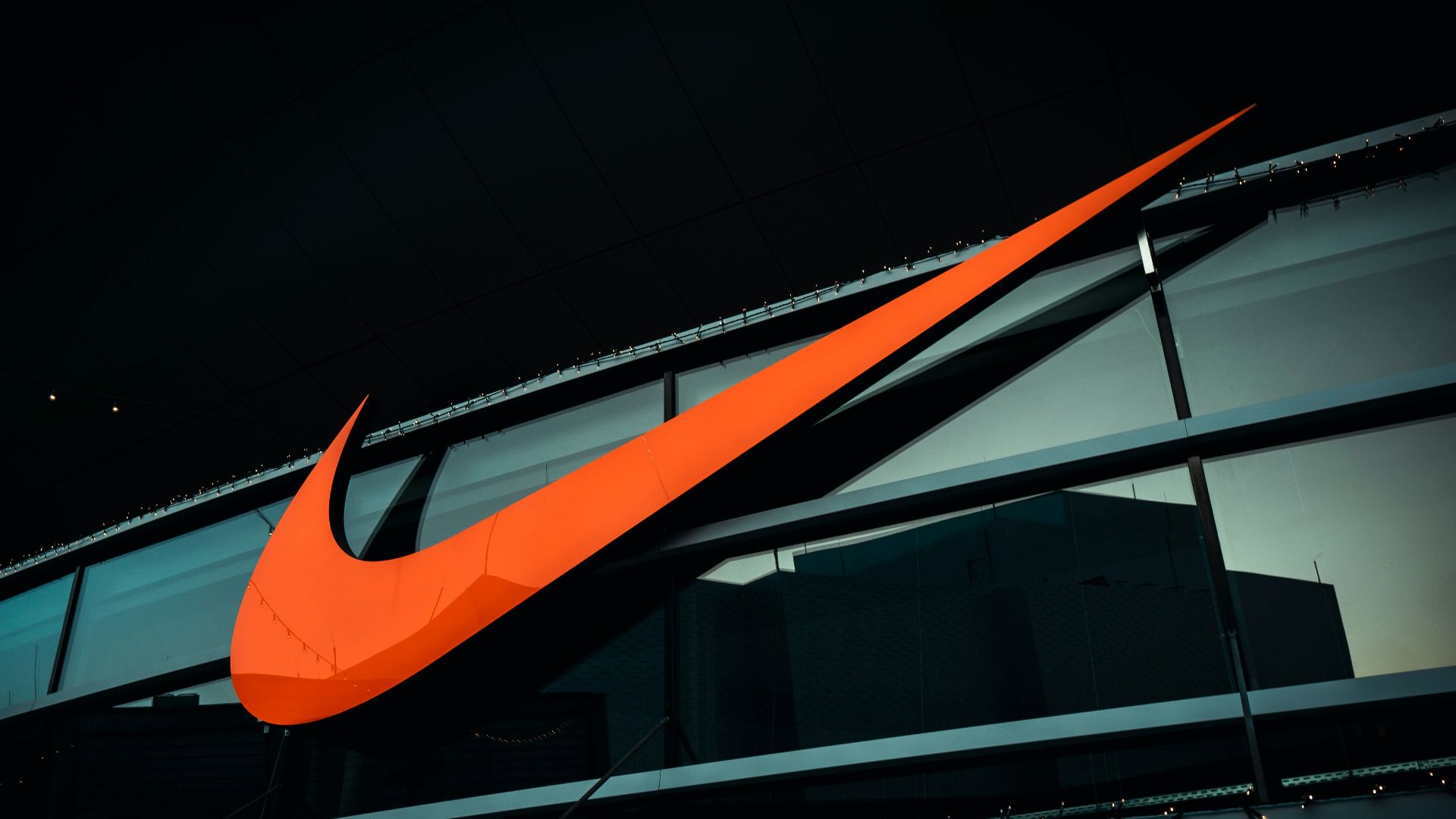 a large orange nike logo on the side of a building