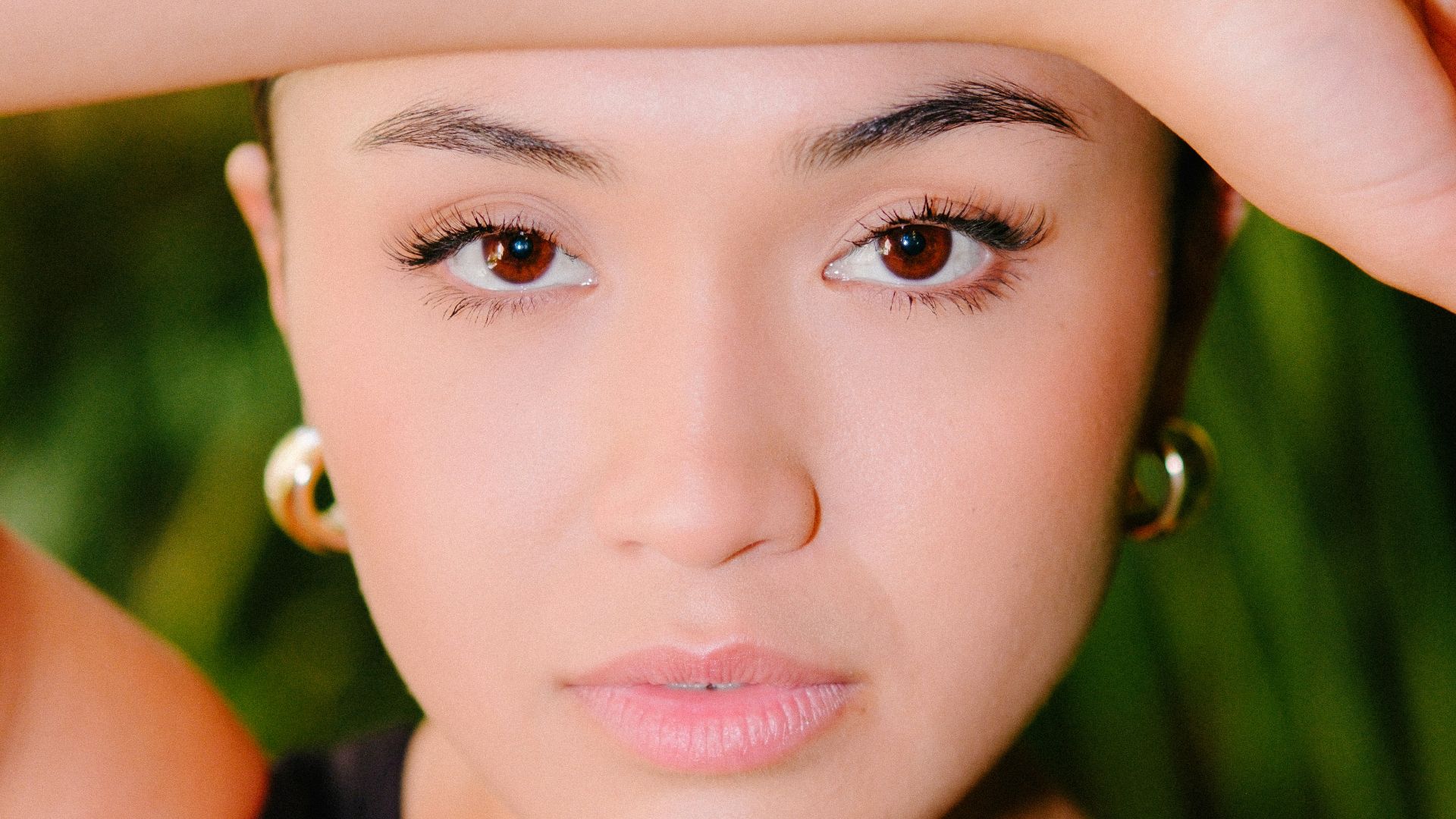 a woman is posing for a picture with her hand on her head