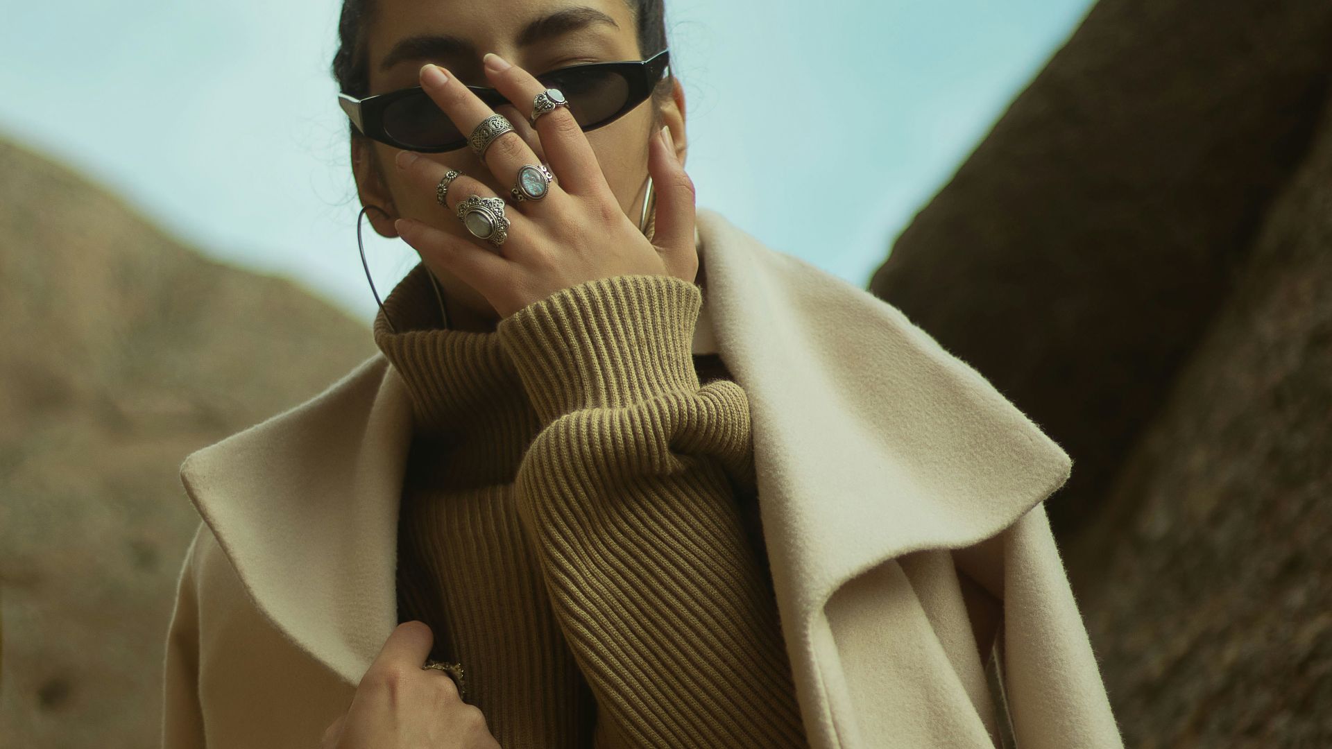 man in brown coat wearing black sunglasses