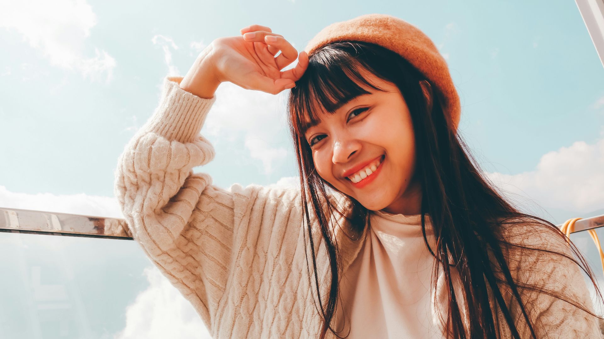 woman in white long sleeve shirt and orange knit cap