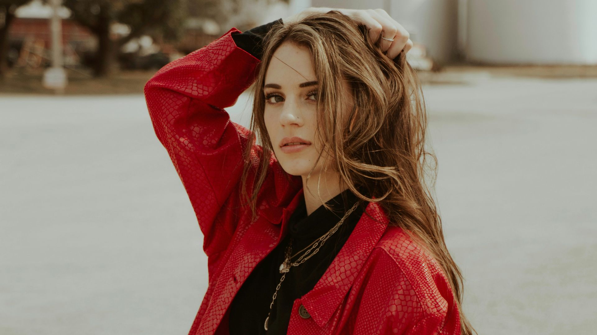 woman in red coat standing on snow covered ground during daytime
