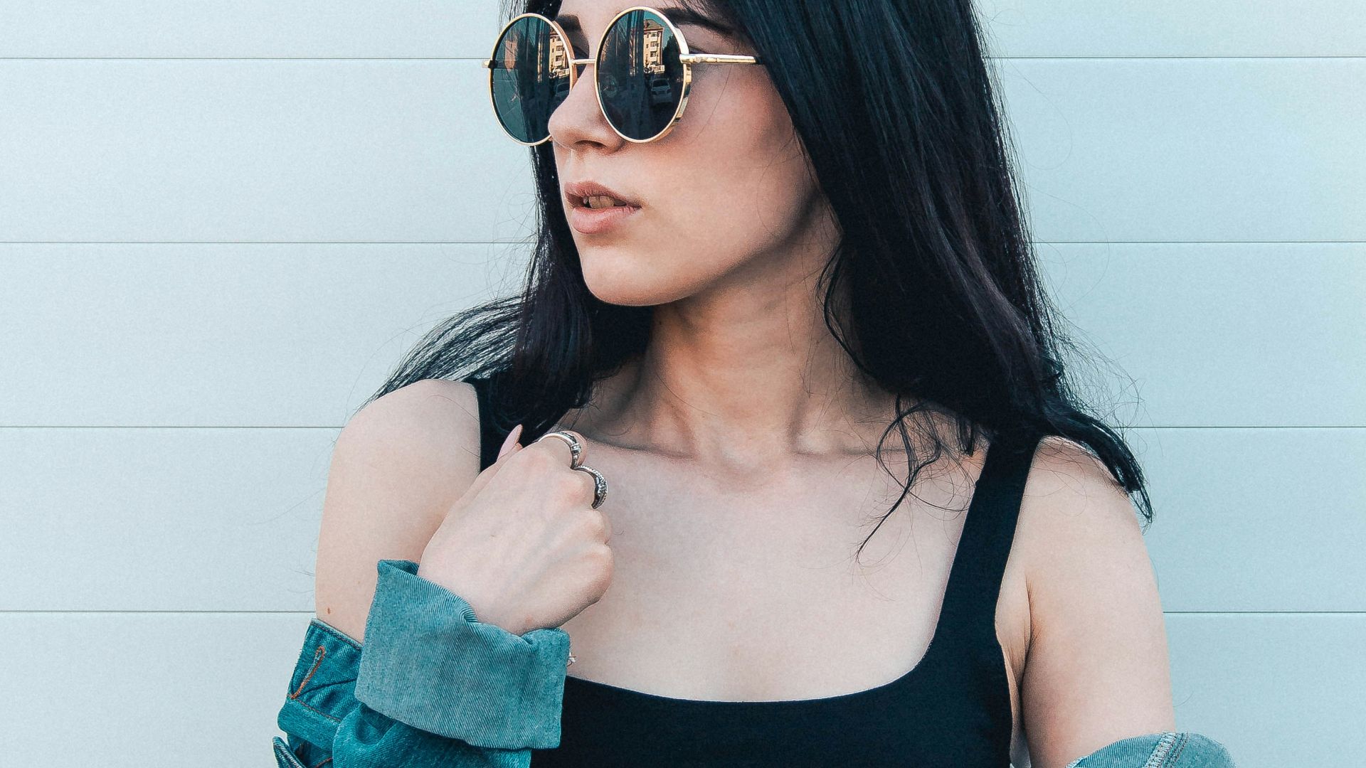 woman posing against a white wall