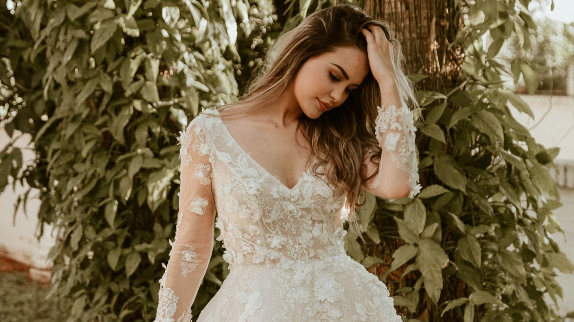 woman in white wedding dress standing near green trees during daytime