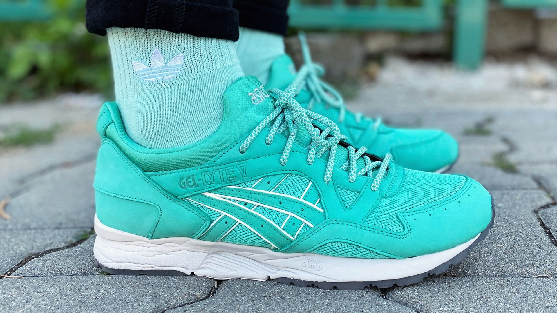 person in green nike athletic shoes