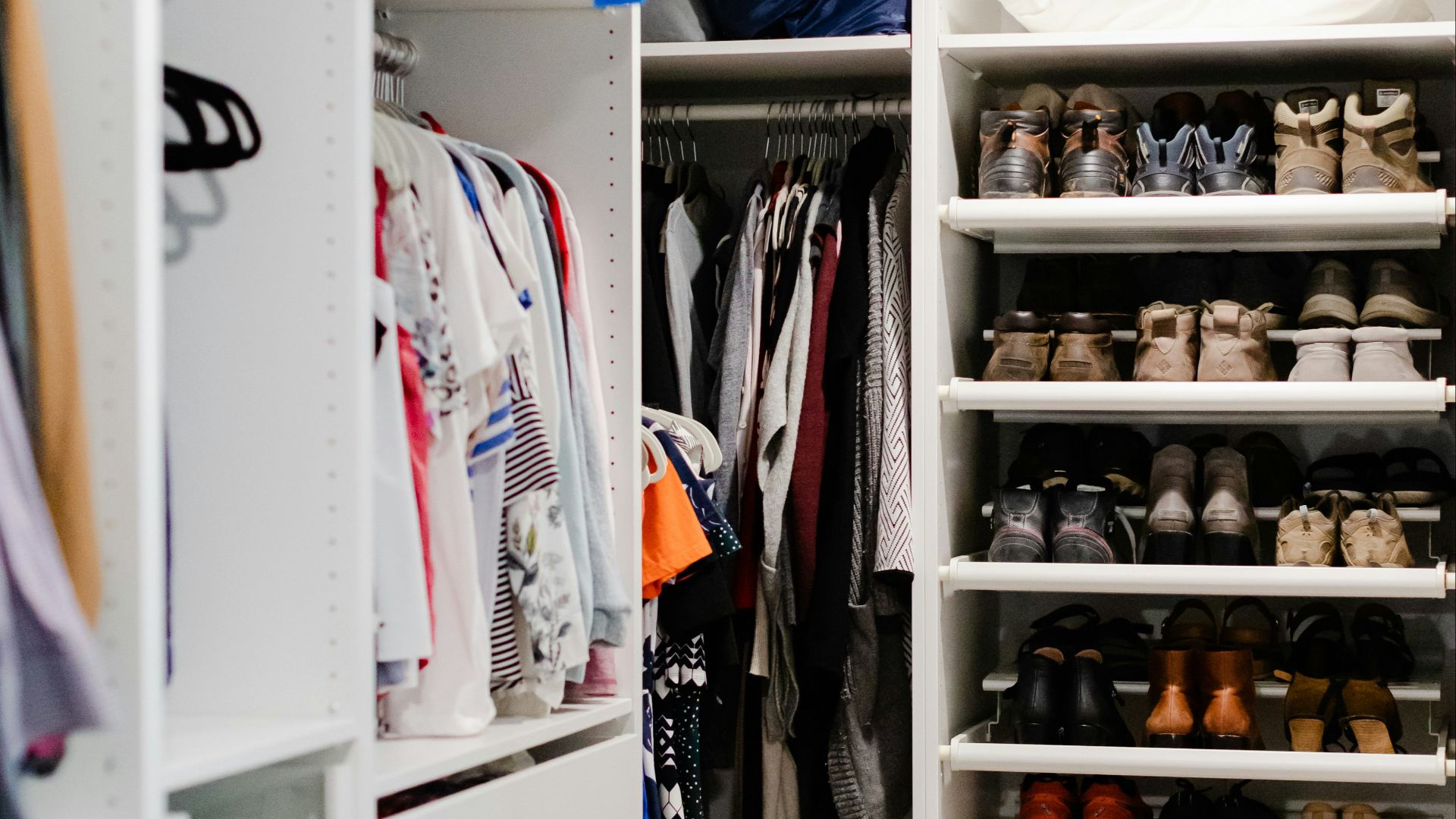a walk in closet filled with lots of shoes