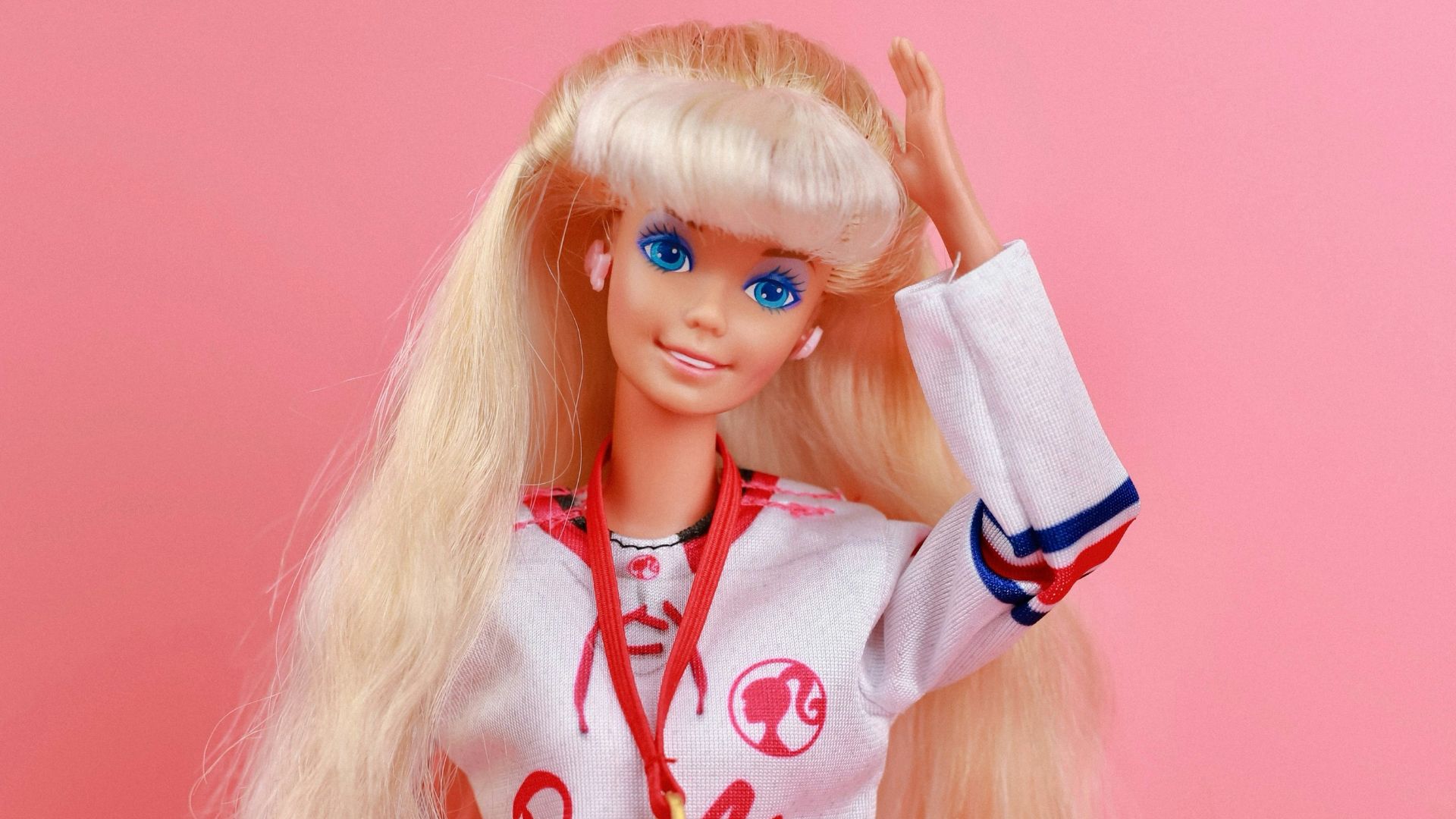 A barbie doll with blonde hair and blue eyes
