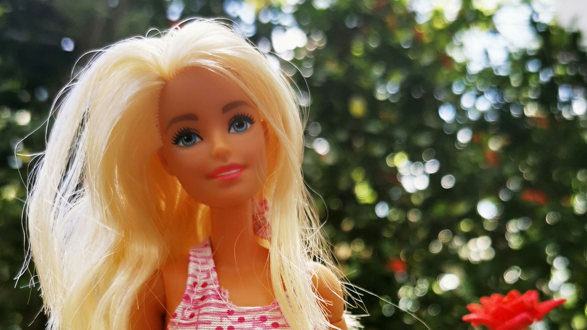 blonde haired girl in red and blue floral dress