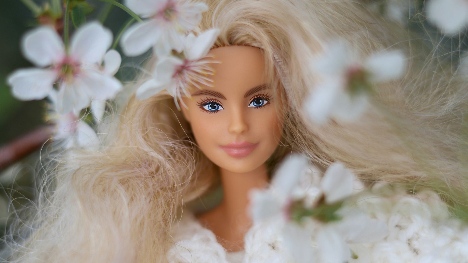 Barbie doll surrounded by beautiful white flowers.